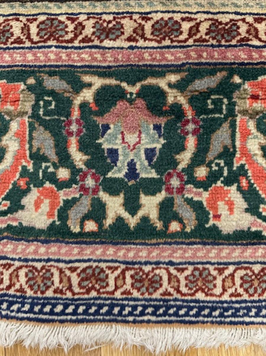Kayseri carpet from central Anatolia (Turkey)

Age: circa 1950

Size: 9′.7″x6′.10″ (292×208 cm)

The cartouche shape dark blue sub field hosts a nested red medallion with complex pendants within a close repeat of rosettes,leaves,stems and