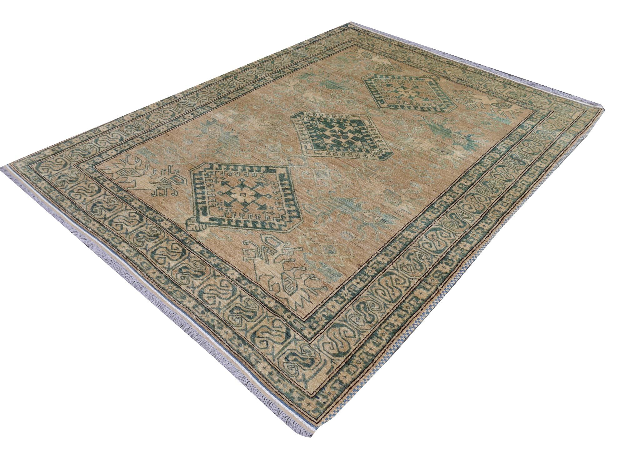 A beautiful vintage rug with Kazak Style Design

Design in style of Kazak hand-knotted.
Colors: Brown, beige, teal, blue 
Pile: 100% highland wool
Size: 8 x 6 ft
Made in Afghansitan

Perfect for loft or Industrial modern rooms. Looks fantastic on