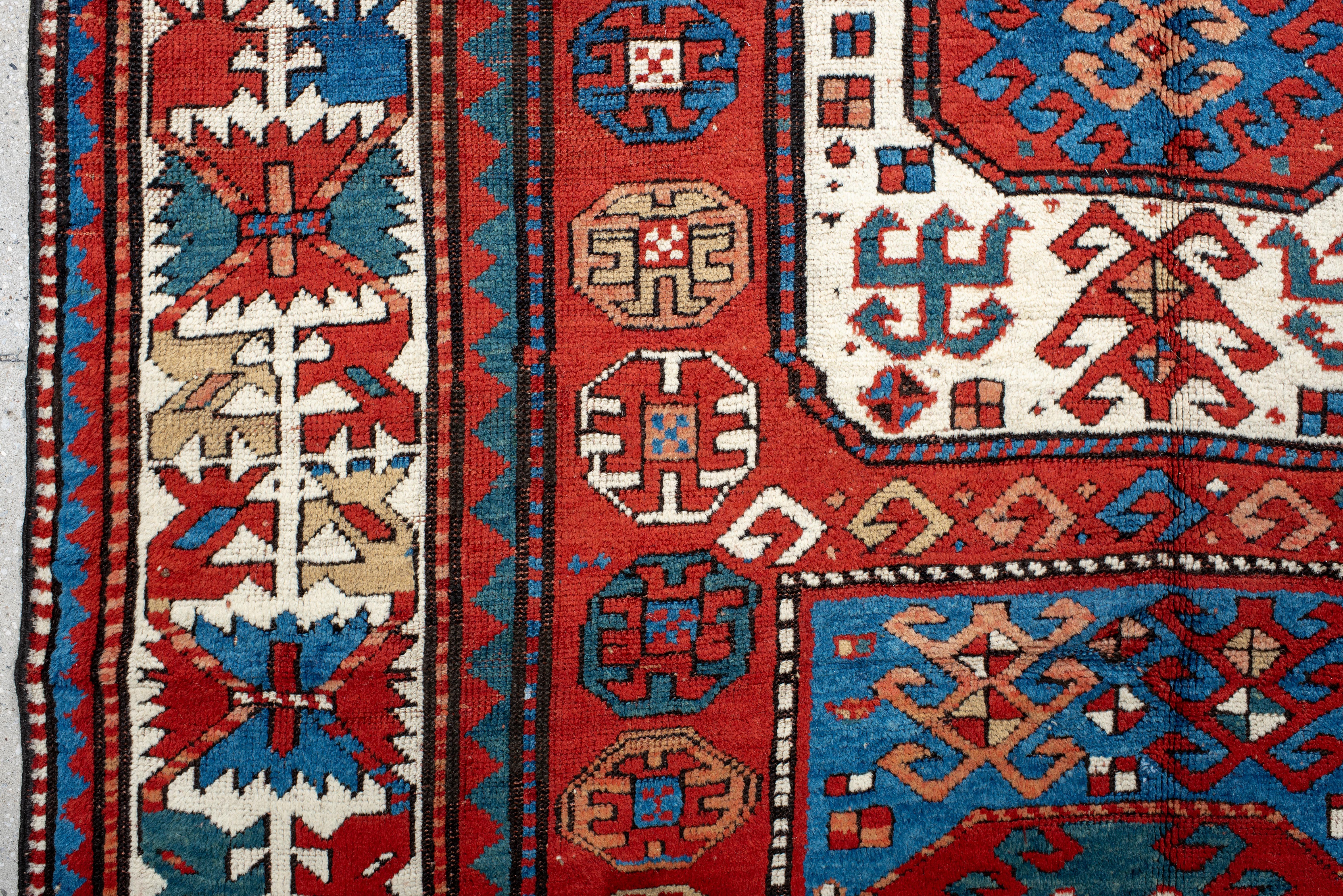 Wool Kazak Rug Tribal Medallion and Hooked Motif Design For Sale
