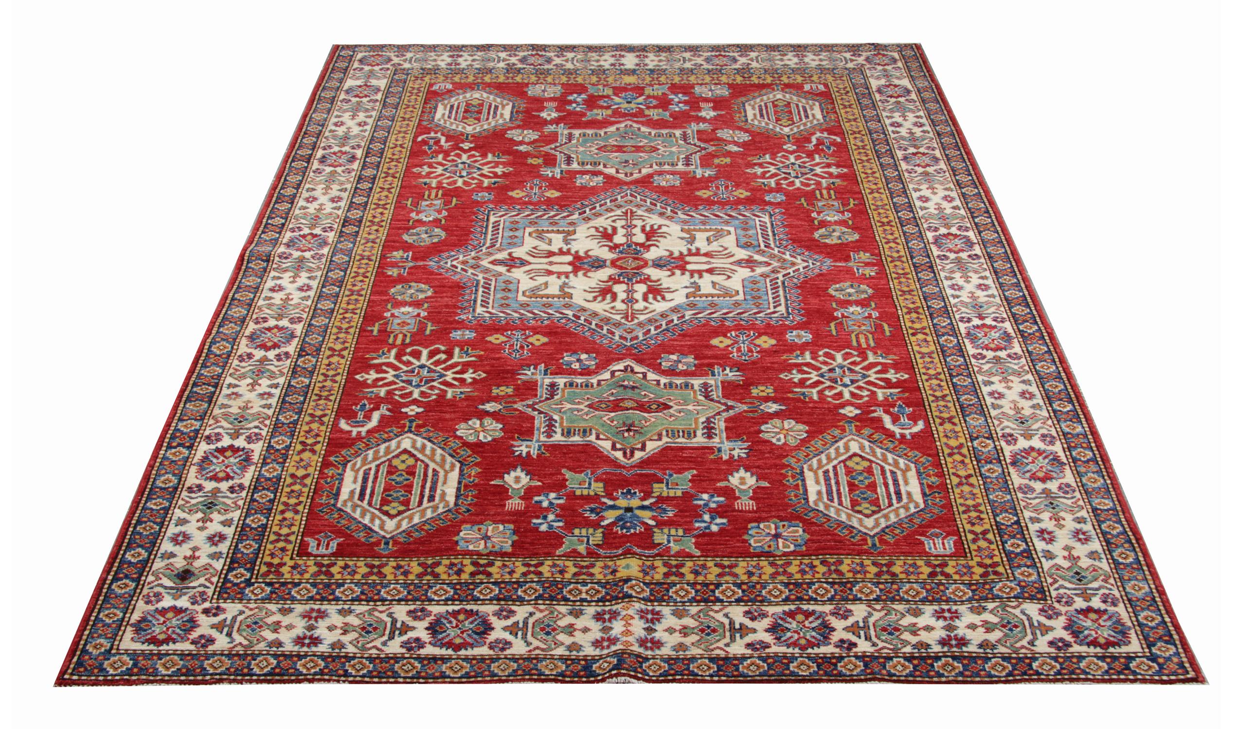 This Kazak red rug has a traditional border with a large medallion. The central area of this tribal rug symbolises a garden of paradise protected by the 'walls' of geometric rug patterns. Traditional rugs would complement your home as floor rugs.