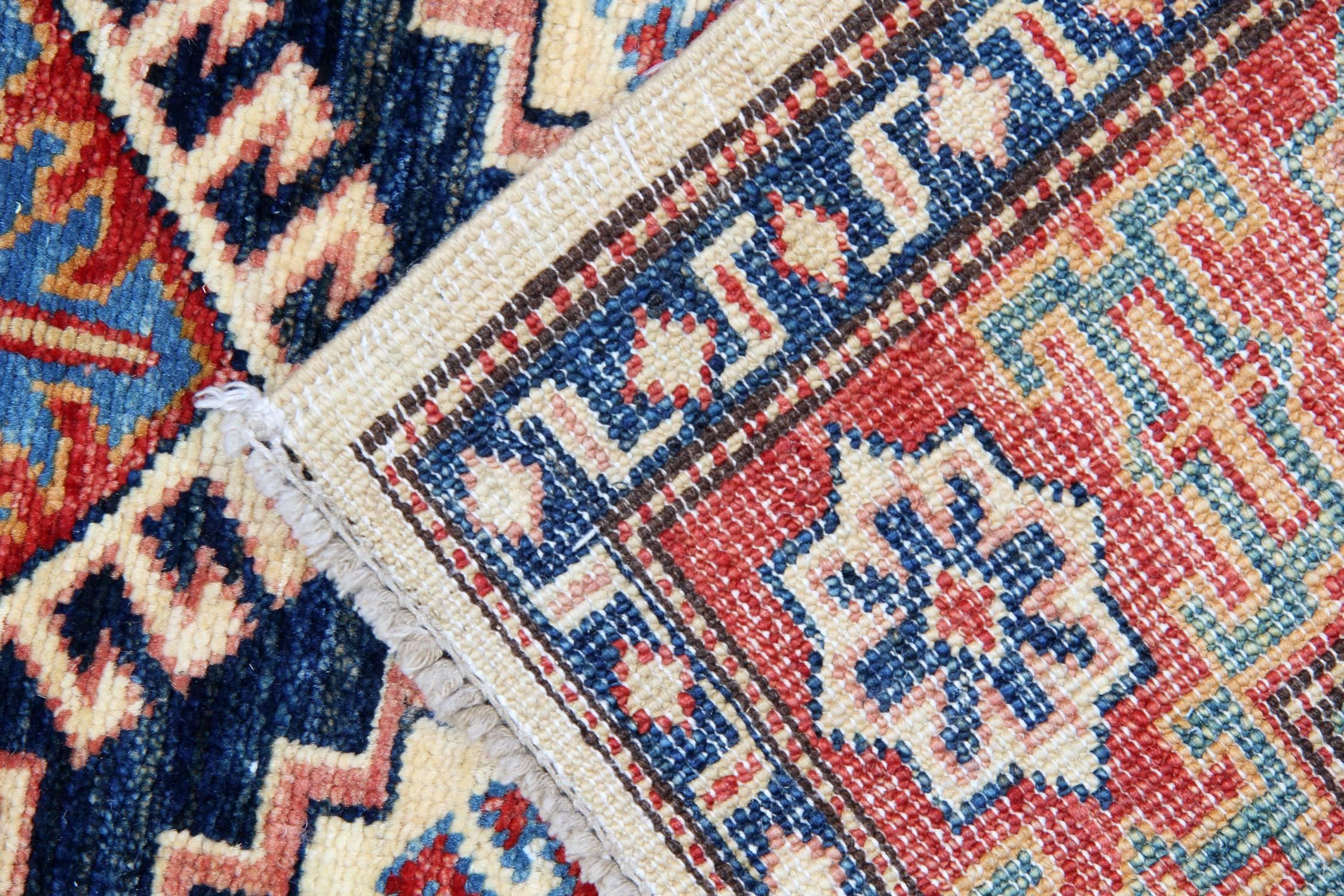 This new traditional handwoven tribal rug with bold colours of cream, light blue and red featuring intricate geometric rug designs of stars, peacocks trees encompassing three medallions. This cream rug is handmade with wool and cotton. Afghan rugs