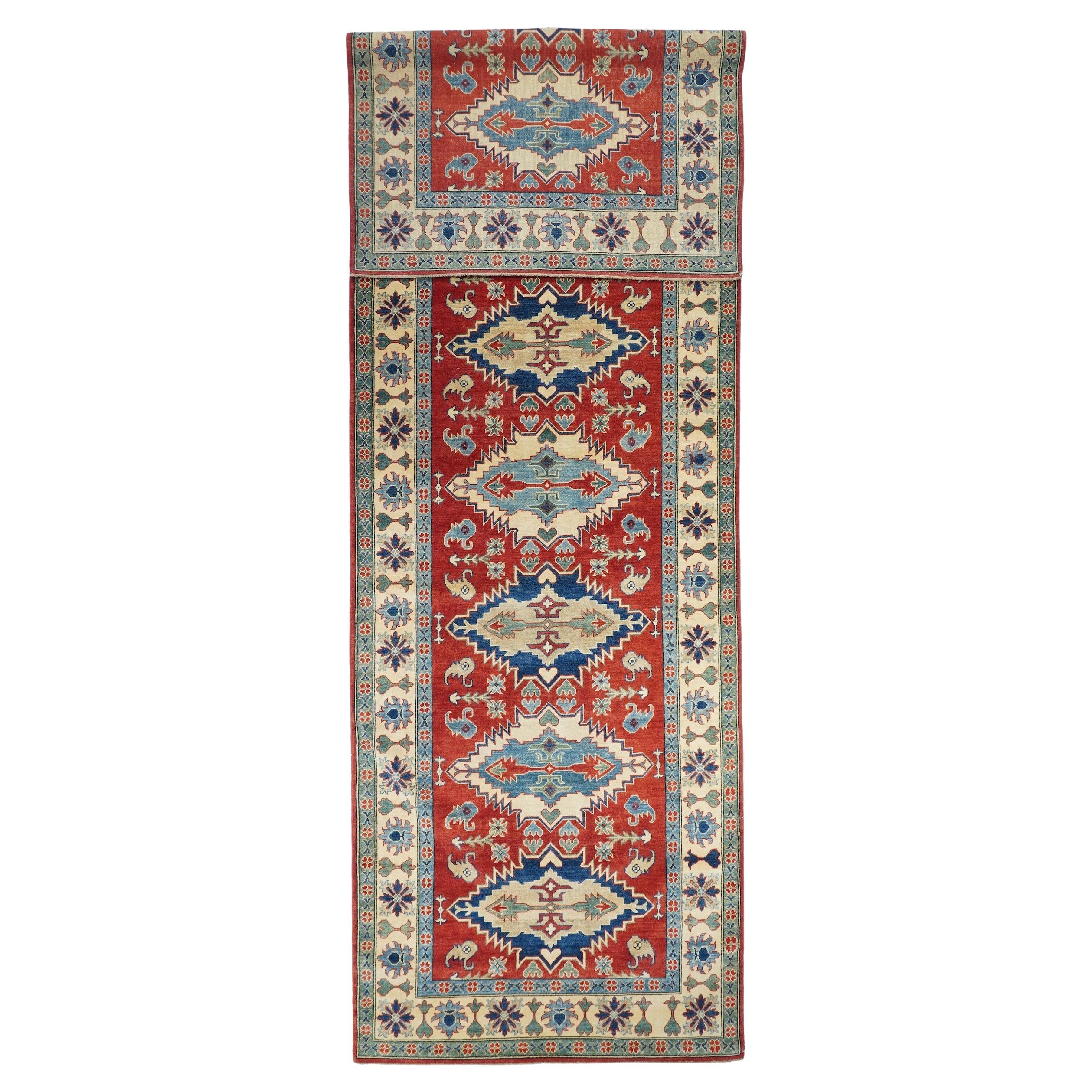 Fine red Pak Kazak runner rug, hand knotted

Design: Diamonds

A Pakistani rug (Pak Persian Rug or Pakistani carpet) is a type of handmade floor-covering textile traditionally made in Pakistan.

The art of weaving developed in the region