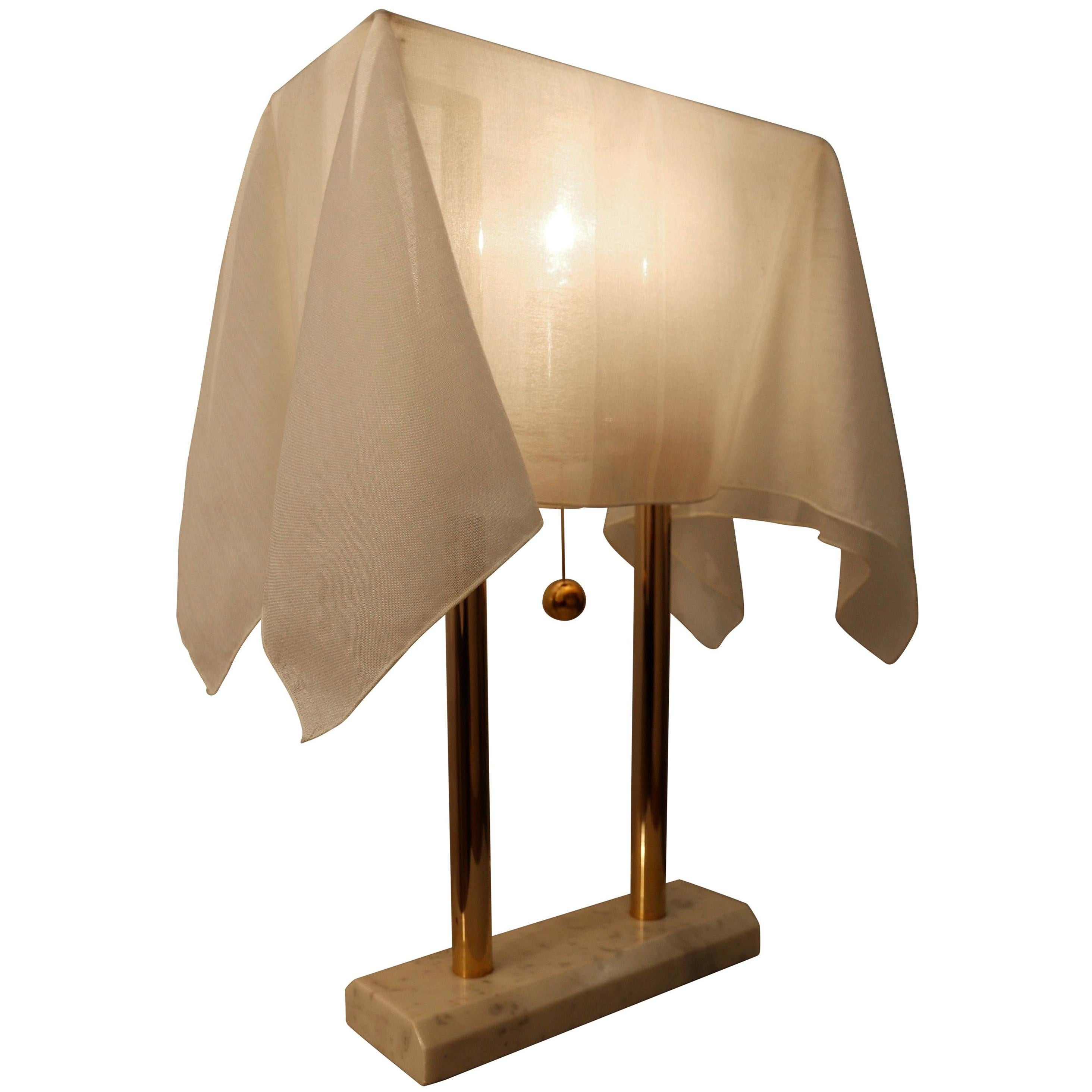 Beautiful and rare table or desk lamp by Japanese designer Kazuhide Takahama, manufactured by Sirrah, Italia, marked with the designer's tag under the base. The lamp features a Carrara marble base with a 23-carat gold-plated metal support, over