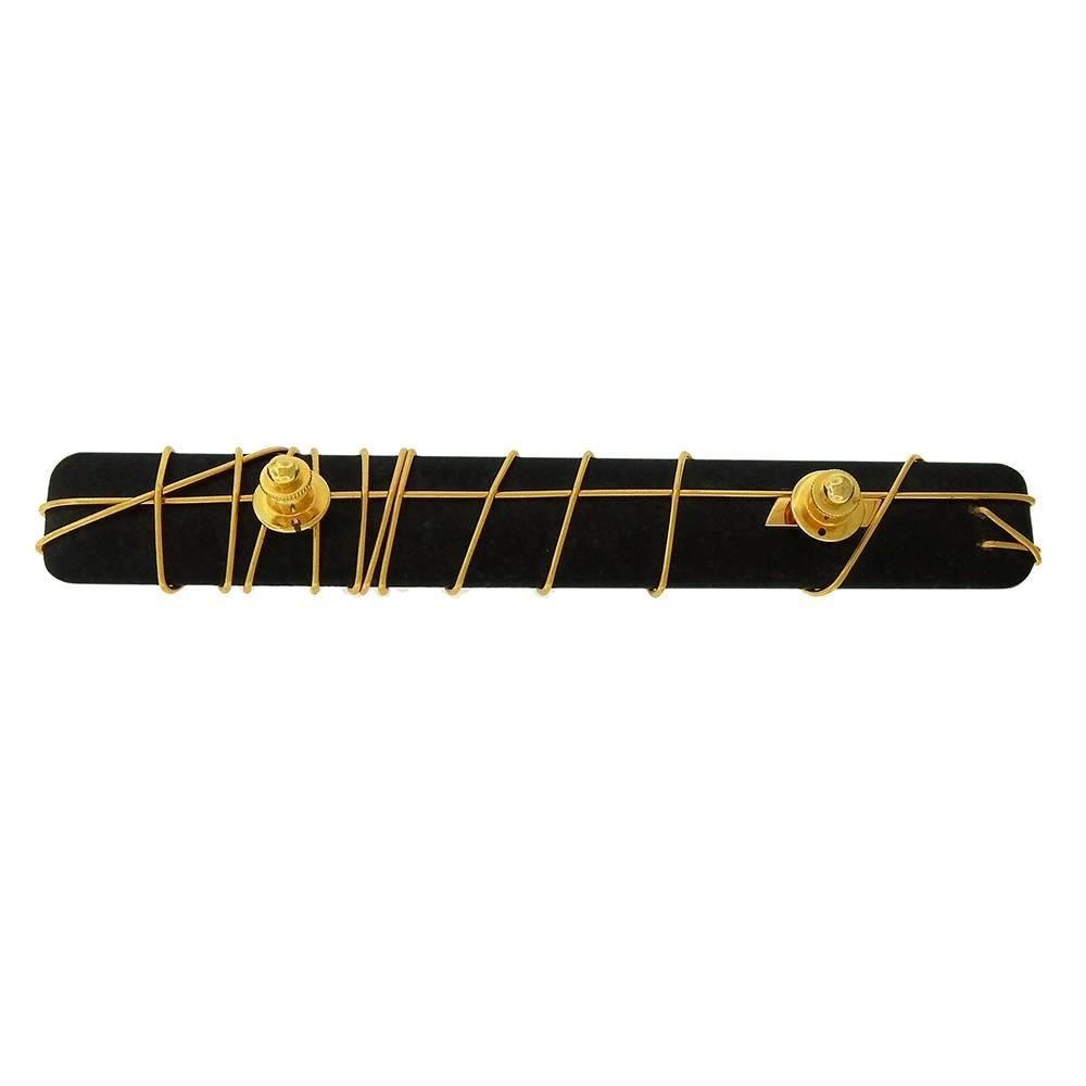 From a private collection, extremely rare work from Japanese modernist Kazuhiro Itoh (1948-1997), a long brooch of polished rectangular granite wrapped in 22K gold wire, tie-tac pins in brass at back, made in 1979.  Measures 5