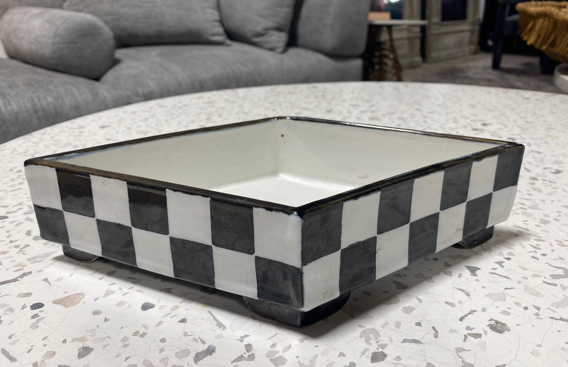 A wonderful, whimsical work by Japanese American, California architectural potter/ artist Kazuko Matthews.

This large black and white checkboard rhombus-shaped bowl/ vessel is signed on the base by Matthews. The piece is reminiscent of the works