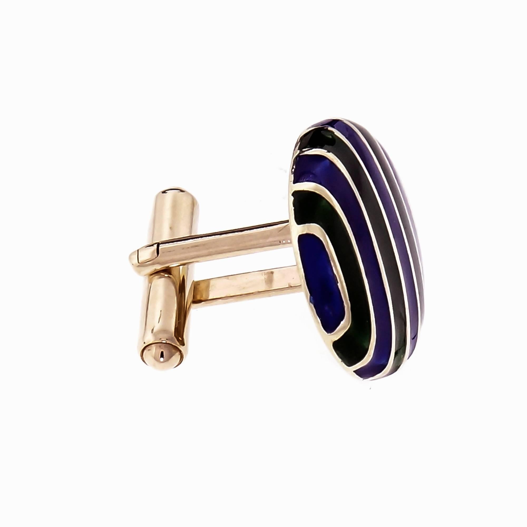 Vintage KBJC oval blue and green enamel striped cufflinks in solid 14k yellow gold with secure clip backs.

14k yellow gold
3.4 grams
Tested and stamped: 14k
Hallmark: KBJC
Top to bottom: 17.41mm or .69 inch
Width: 22.22mm or .88 inch
Depth: 4.34mm
