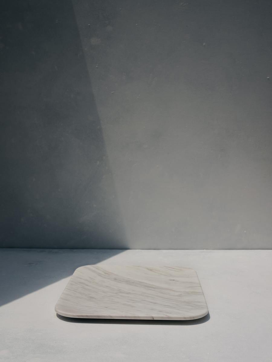 Kea tray by Faye Tsakalides. 
Dimensions: 20 W x 25 L x 1.5 H cm
Materials: White Volakas marble,
Technique: Crafted from a single piece of marble. Hand-crafted, Polished. Mat finished. 

Faye Tsakalides, Founder and Creative Director of White