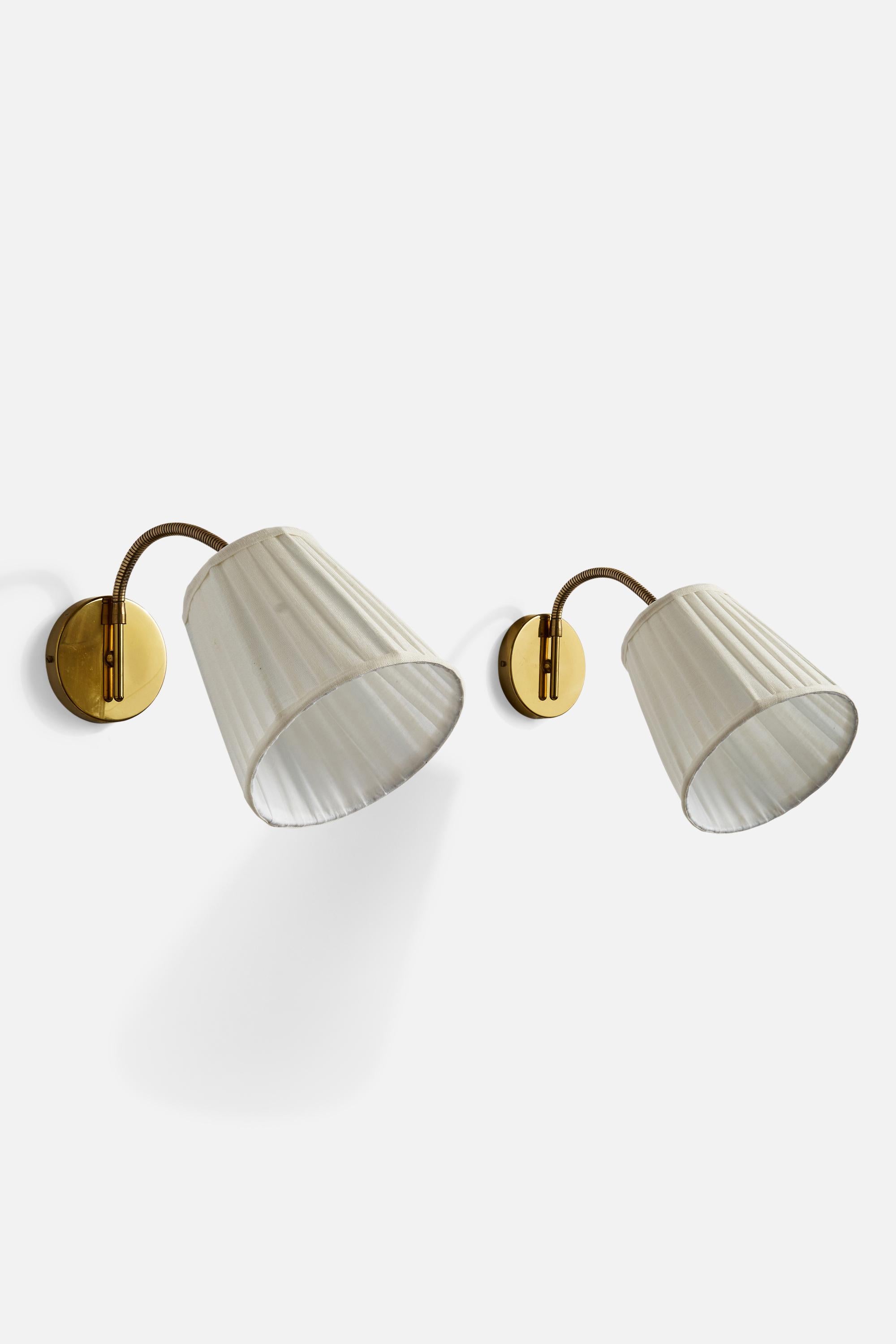 A pair of adjustable brass and white fabric wall lights designed and produced by KEAK Belysning, Sweden, 1970s.

Dimensions variable.
Overall Dimensions (inches): 21.75” H x 8” W x 12” D
Back Plate Dimensions (inches): 4.75”  H x 4.75”  W x .75”