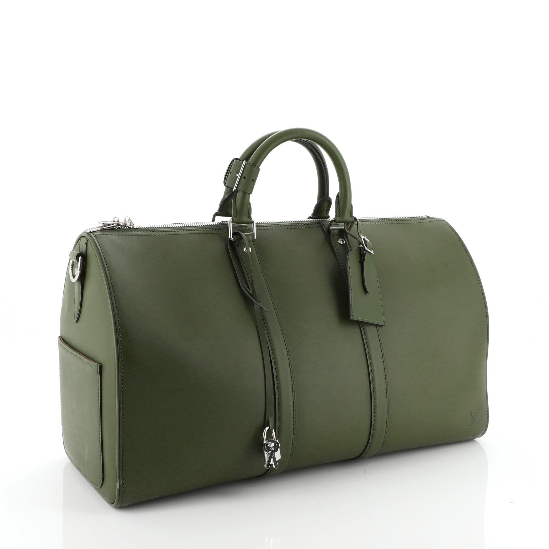 This Louis Vuitton Keepall Bandouliere Bag Nomade Leather 45, crafted in green leather, features dual rolled handles and silver-tone hardware. Its zip closure opens to a brown microfiber interior. Authenticity code reads: BA4122. 

Estimated Retail
