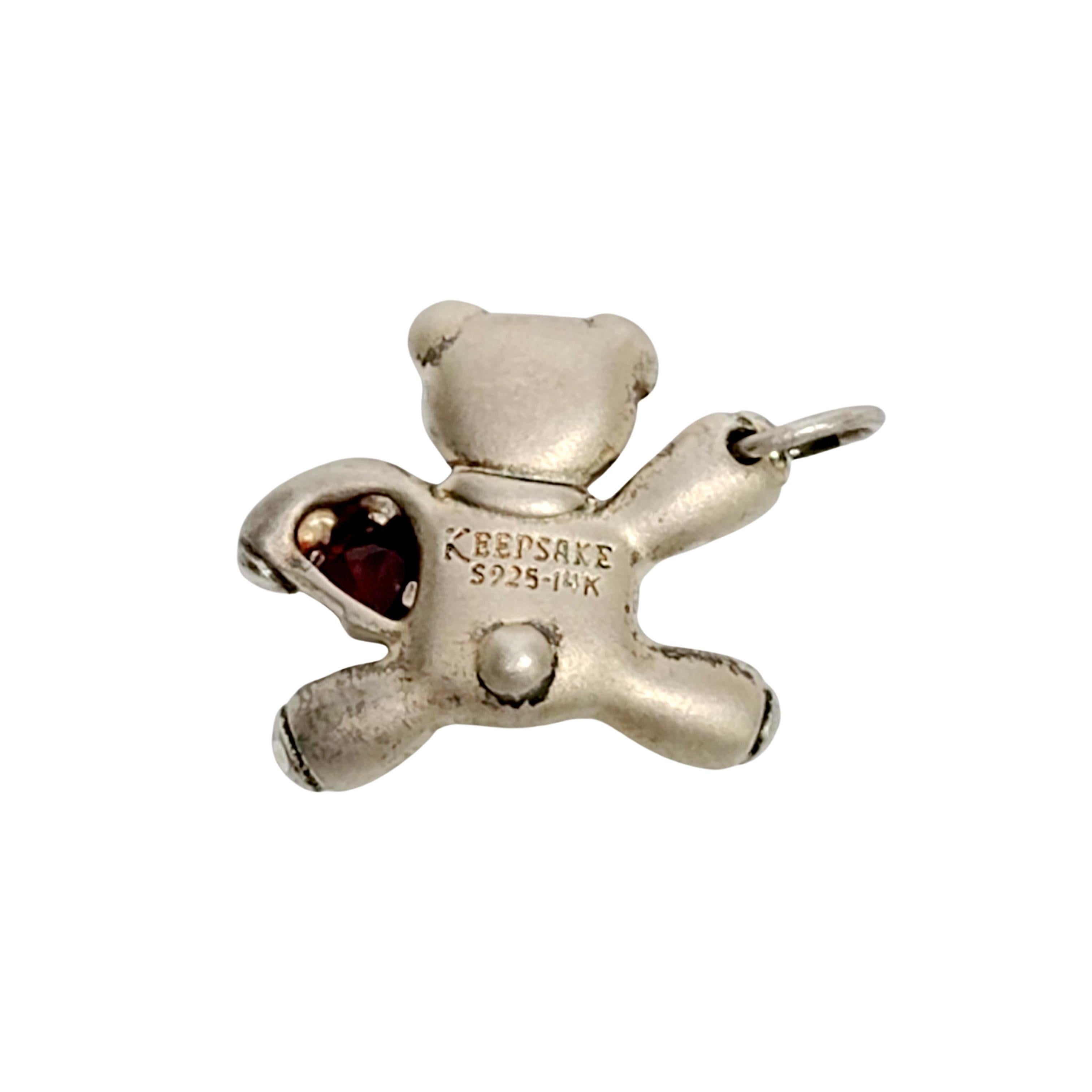 Sterling silver teddy bear pendant featuring a garnet heart and an initial L.

Adorable teddy bear pendant holding a garnet heart and wearing a gold scarf with the initial L.

Measures approx  3/4