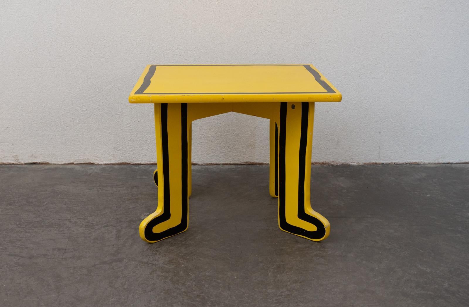 Quirky yellow kids table made by Vilac France 2000s designed by Keith Haring (USA 1958–1990).