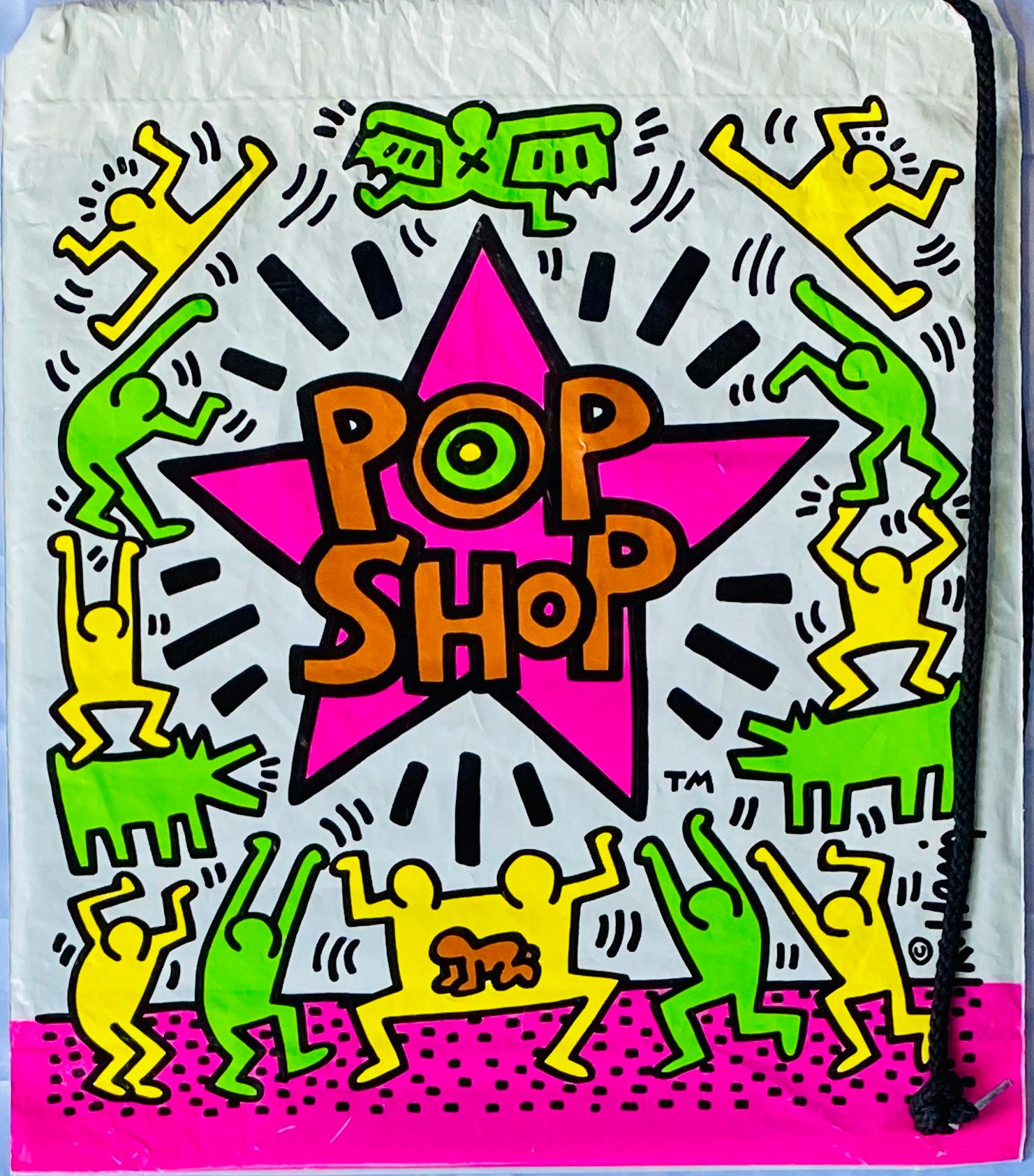 Keith Haring Pop Shop, 1986:
Vintage original 1980s Keith Haring Pop Shop bag designed & illustrated by the artist. Features a bold Keith Haring printed signature and standout original Haring Pop shop logos, plus bright, lush colors which make for a