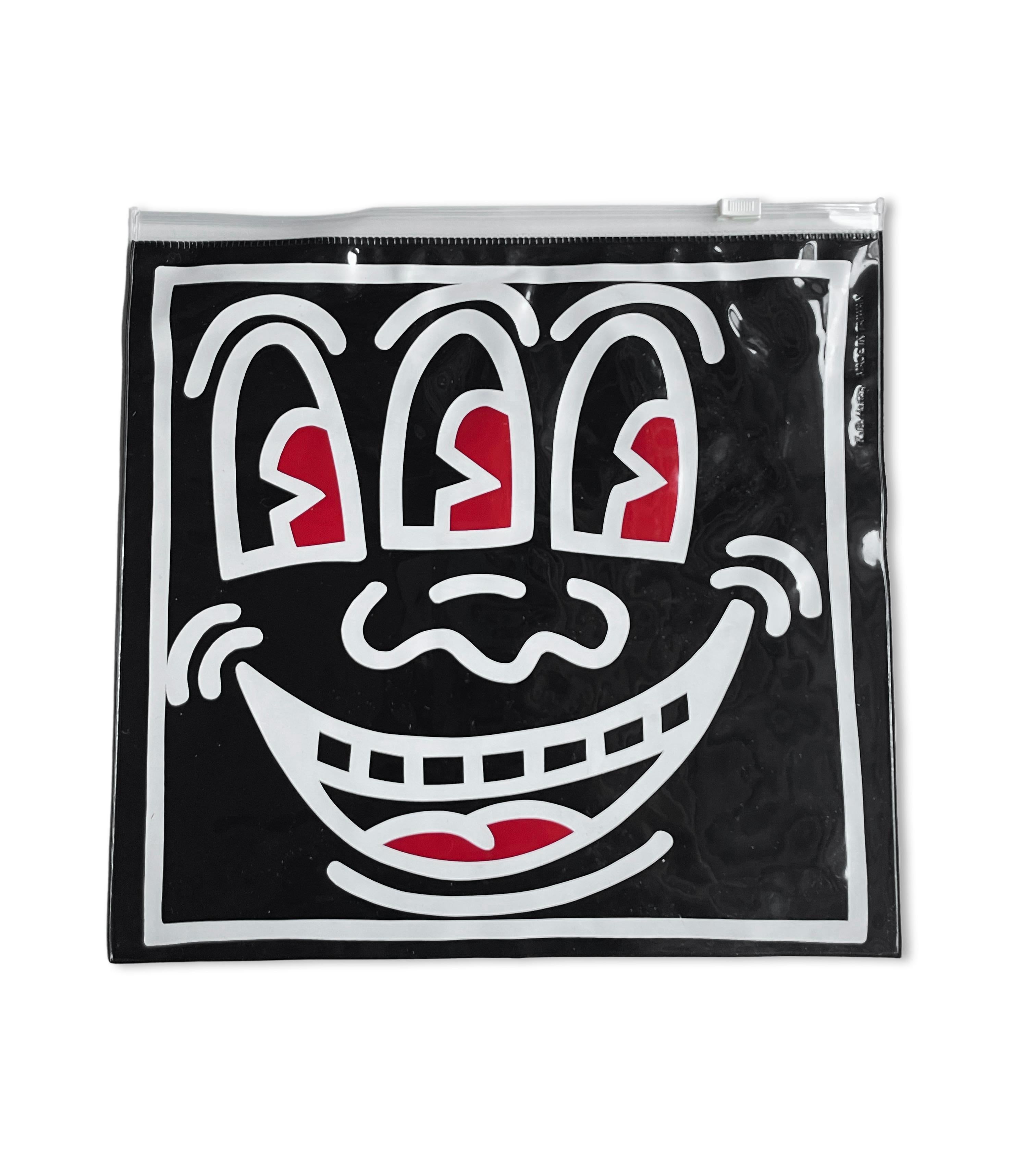 Keith Haring Pop Shop bag c.1987:
Rare original 1980s Keith Haring Pop Shop collectible featuring Keith Haring’s Three Eyed Smiling Face on a double-sided vinyl pouch. A classic 1980s Keith Haring Pop Shop collectible that is well-suited for