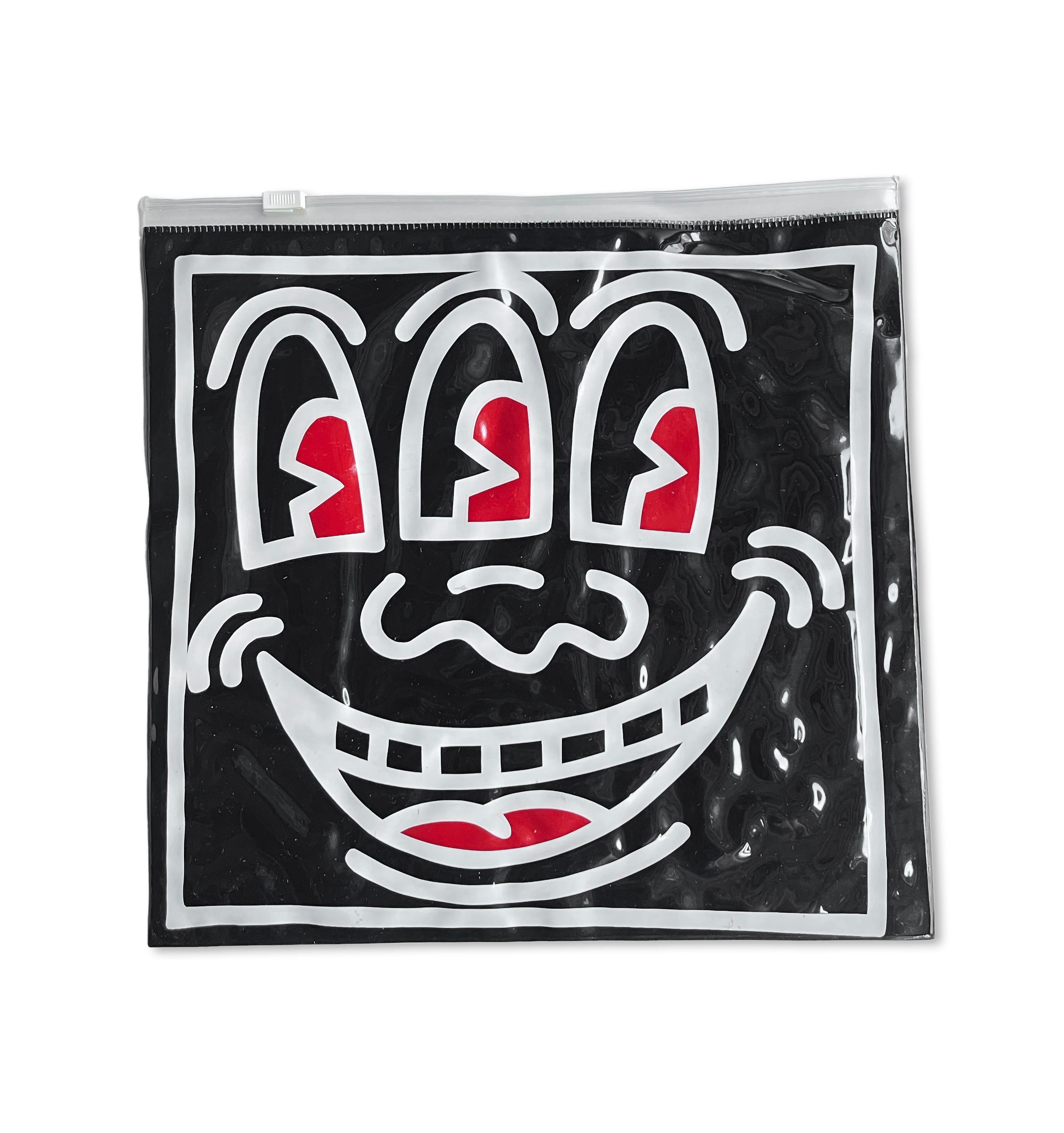 Keith Haring Pop Shop bag c.1987:
Rare original 1980s Keith Haring Pop Shop collectible featuring Keith Haring’s Three Eyed Smiling Face on a double-sided vinyl pouch. A classic 1980s Keith Haring Pop Shop collectible that is well-suited for