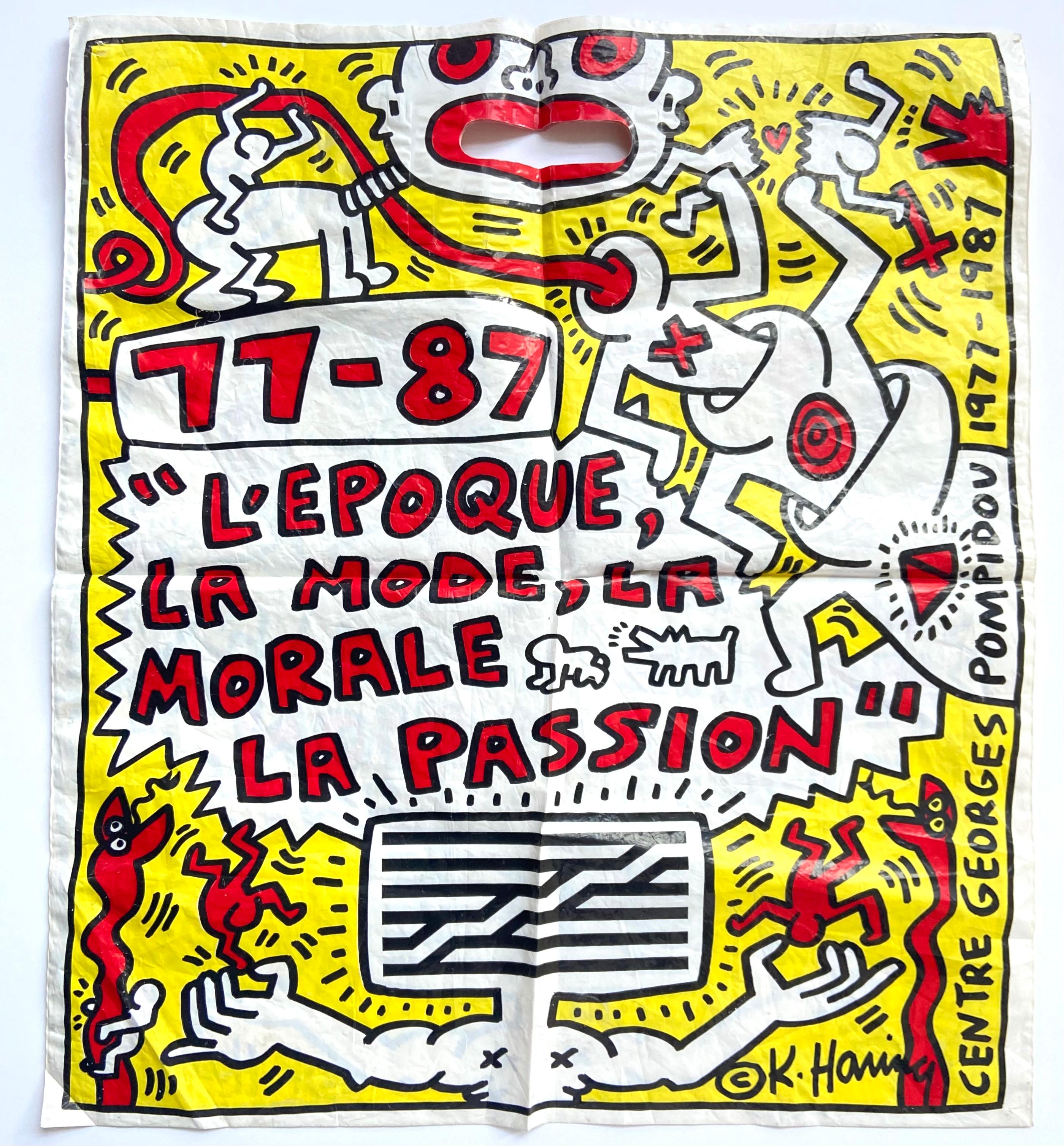 Keith Haring Paris, 1987:
Well-suited for framing, this vibrant oversized illustrated bag was designed by Keith Haring during his lifetime for the Pompidou exhibit:

L’Epoque, La Mode, La Morale, La Passion: Aspectsde l’Art d’ Aujourd’hui,