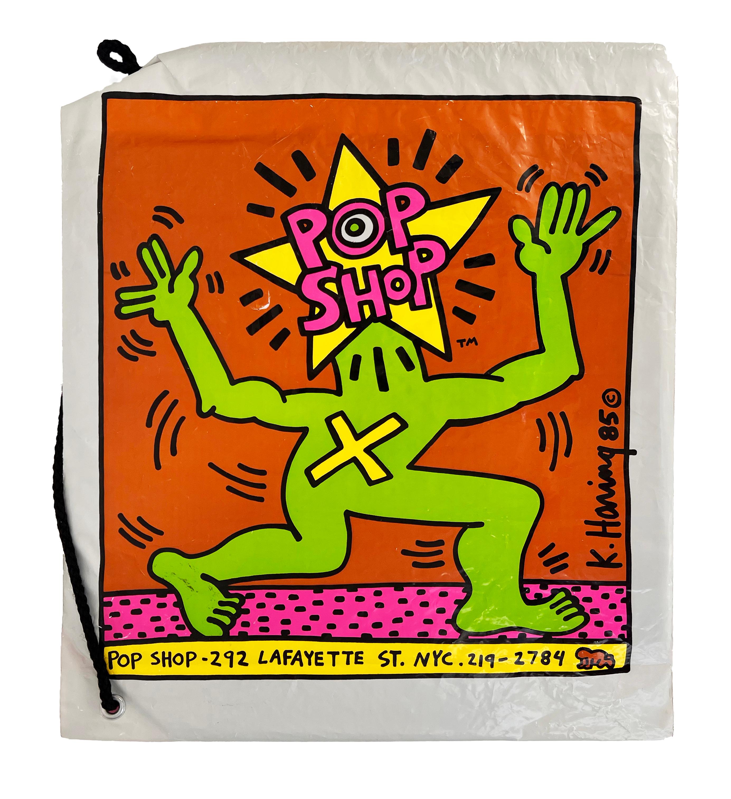Keith Haring Pop Shop Bags set of 2, 1986:
Vintage original 1980s Keith Haring Pop Shop bag set designed & illustrated by the artist. Both feature a bold Keith Haring printed signature and standout original Haring Pop shop logos, plus bright, lush