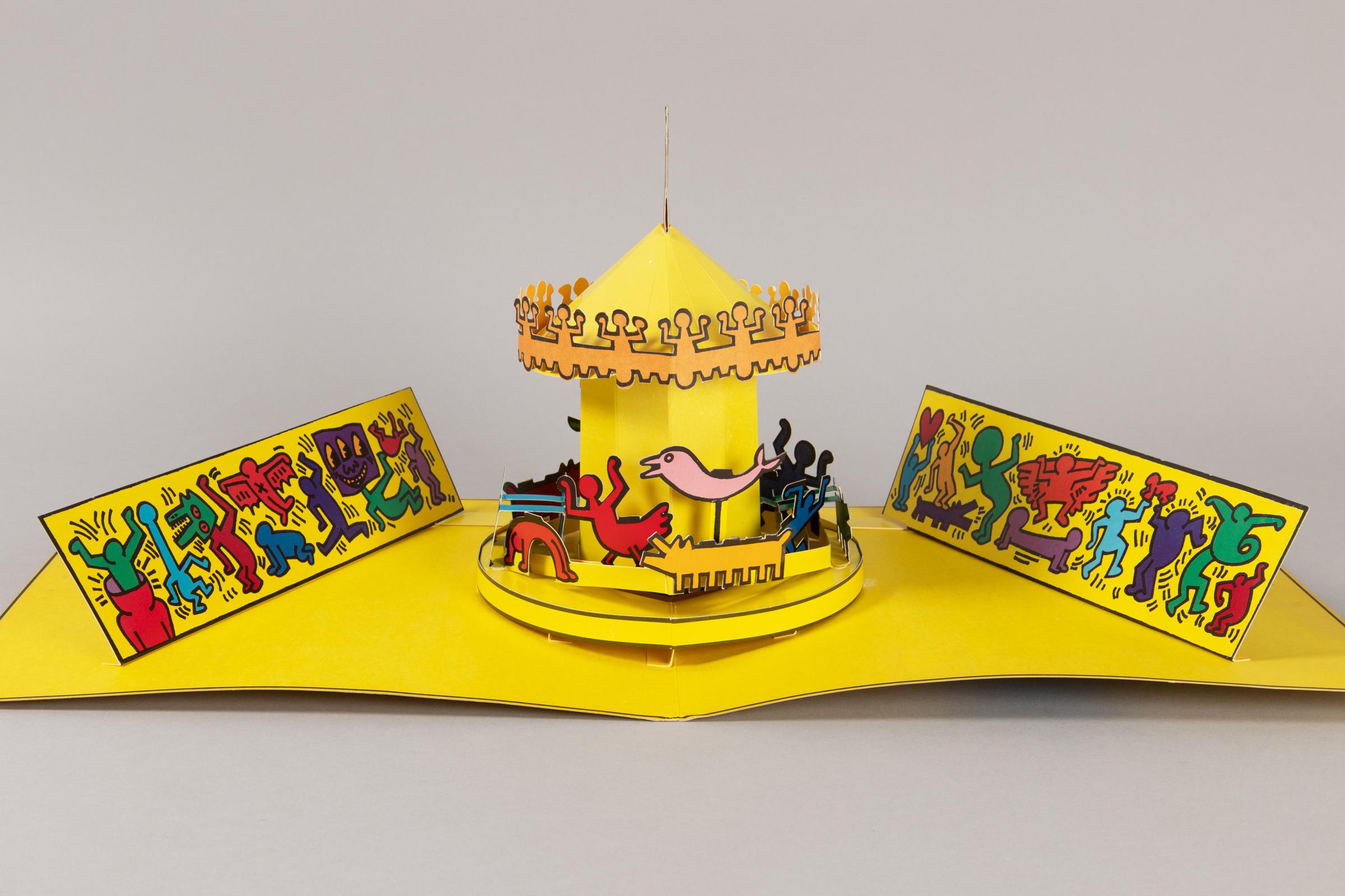 Keith Haring 1958–1990
Luna Luna Karussell, A Poetic Extravaganza!, 1986
Medium: Pop-up cardstock multiple (Color offset print on colored cardboard, shaped and carved)
Dimensions unfolded: 7½ h × 24 w × 12 d in (19 × 61 × 30 cm)
Edition size: