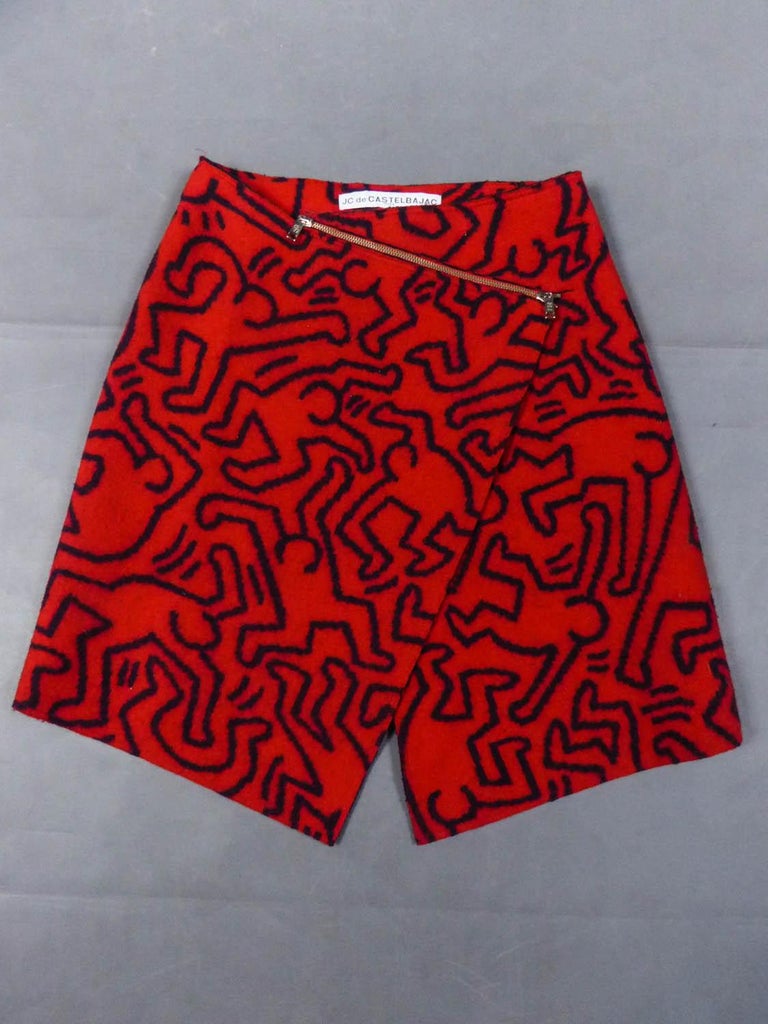 Circa 1990/2000
France

Iconic skirt in red woolen printed with graffiti by Keith Haring from the famous French couturier Jean-Charles de Castelbajac. Thick boiled wool printed in reversible, navy-blue on red on the outside and red on navy-blue on