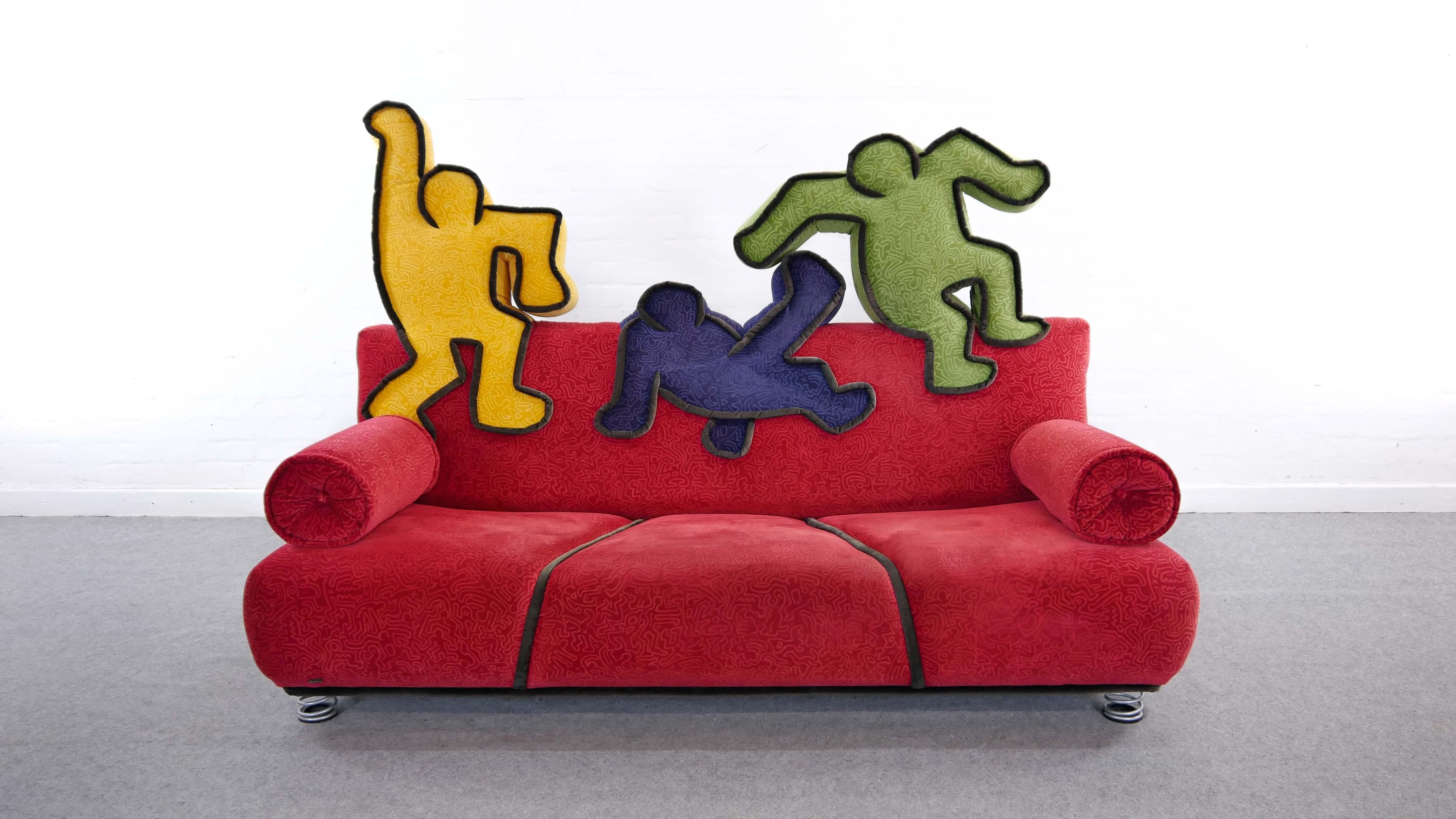 Pop Art Design. Keith Haring 3-seat sofa for Bretz, Designed in colaboration with the Haring Foundation 2002, Pop - Art Design, Original upholstery in red velvet-like fabric with small Haring motives. Backrest with 3 classical Haring figures in