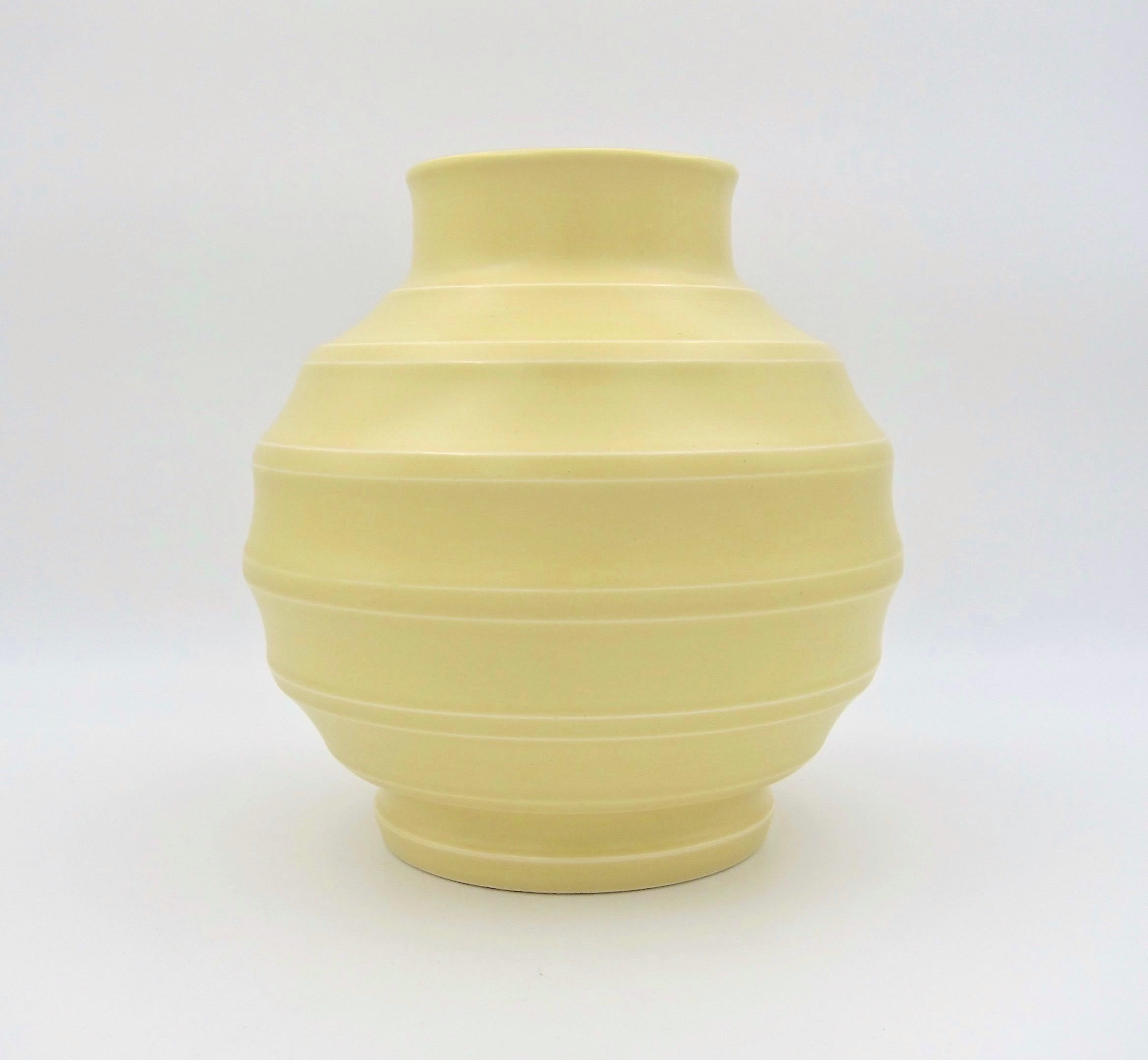 A spherical Art Deco vase by New Zealand born architect, potter, and designer, Keith Murray (1892-1981) for Wedgwood of England, dating to the 1930s. Murray designed this vase in 1932 and his printed signature appeared on the base until