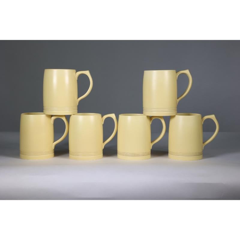 Keith Murray for Wedgwood. A rare complete and original set of six soft straw-coloured lemonade mugs, which have been together all their lives and they are all mint.
