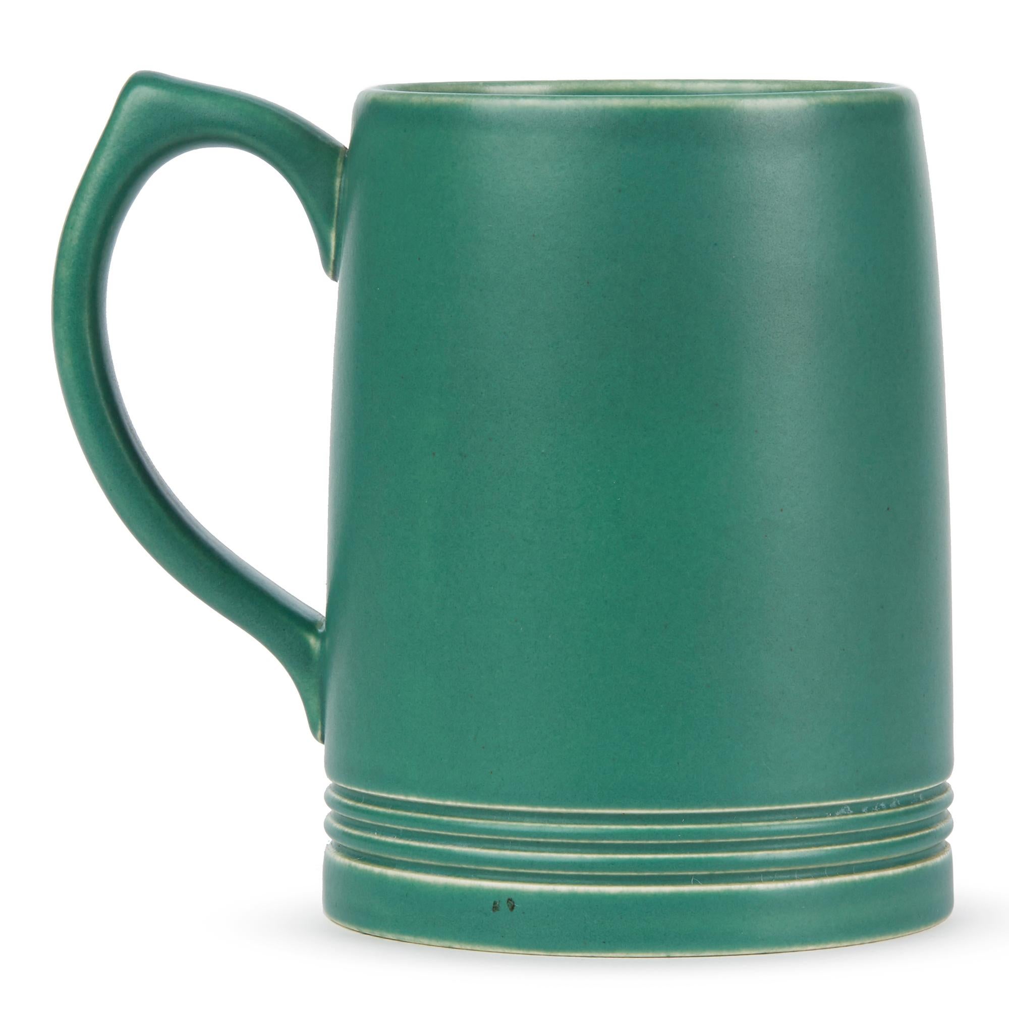 A good iconic Art Deco Wedgwood green glazed pottery mug designed by Keith Murray and dating from circa 1935. The mug has an incised signature mark to the base. Offered in excellent condition.