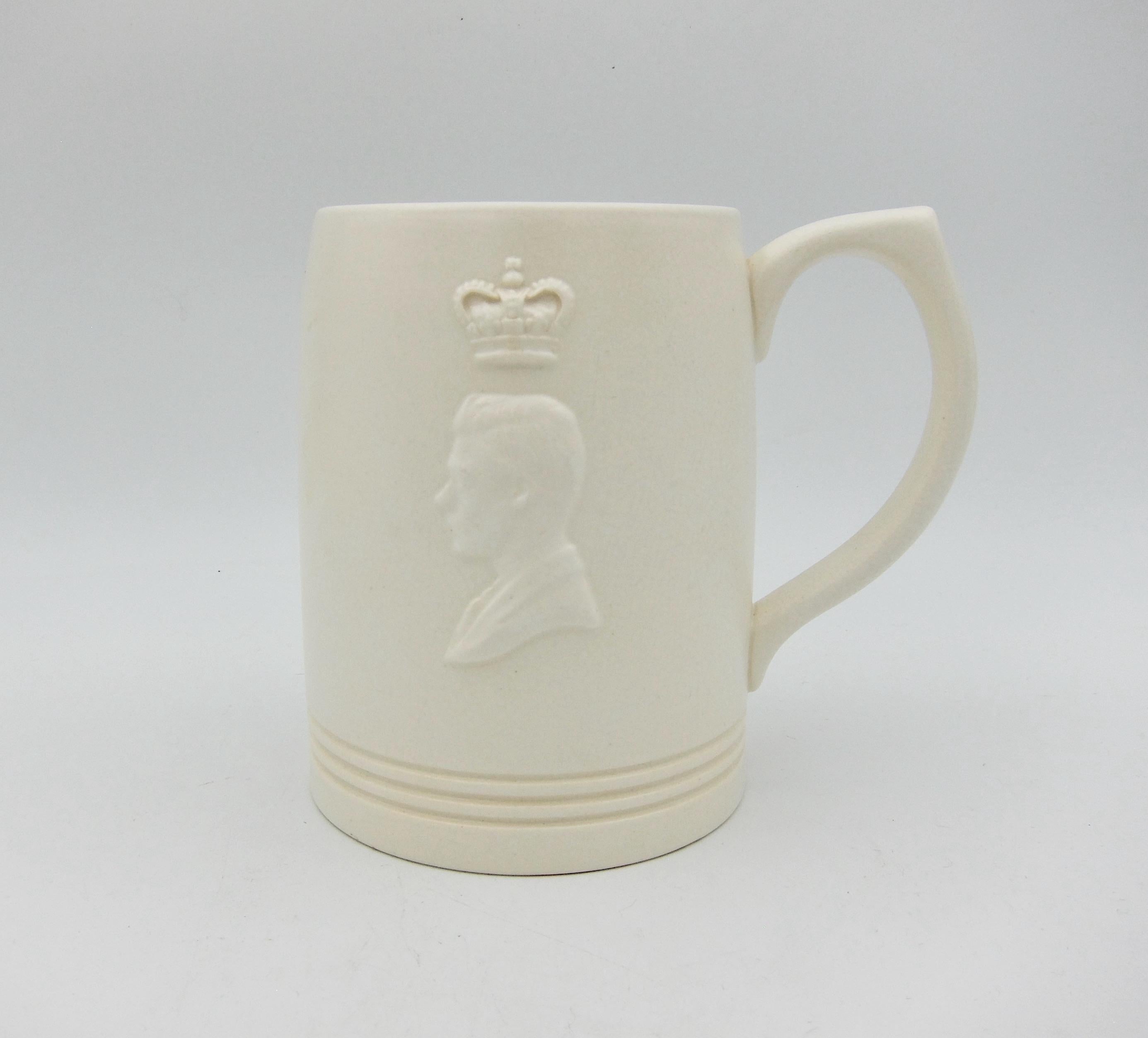 An English tankard style mug designed by New Zealand born architect, potter, and designer, Keith Murray (1892-1981) for Wedgwood. Murray designed this commemorative mug for the 1937 coronation of King Edward VIII which was canceled upon his