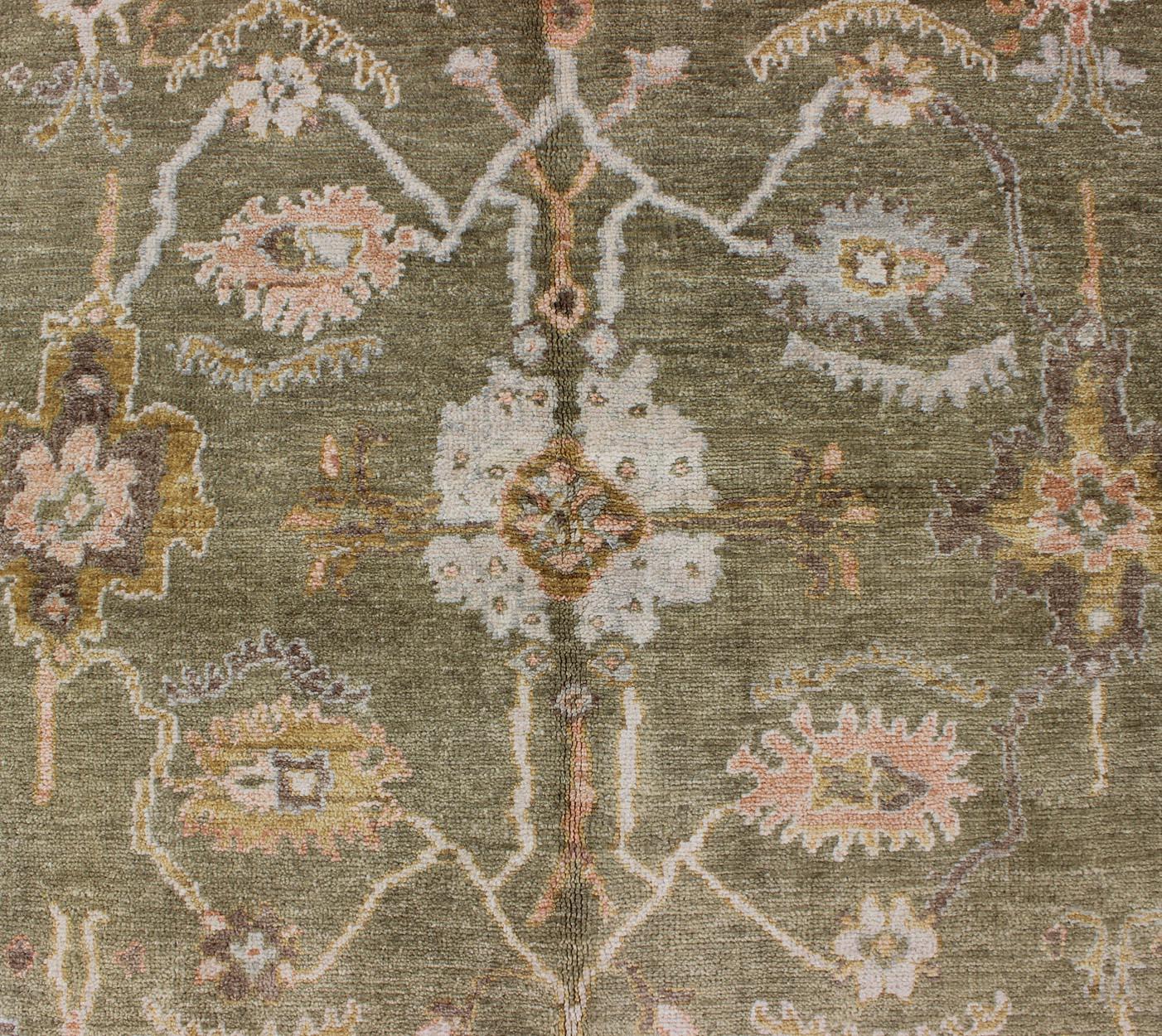 Reproduction Oushak rug with muted tones and neutral color palette and all-over floral design. Keivan Woven Arts / rug BDH-712862, country of origin / type: India/ Oushak

This New hand knotted Oushak rug features a beautiful design rendered in