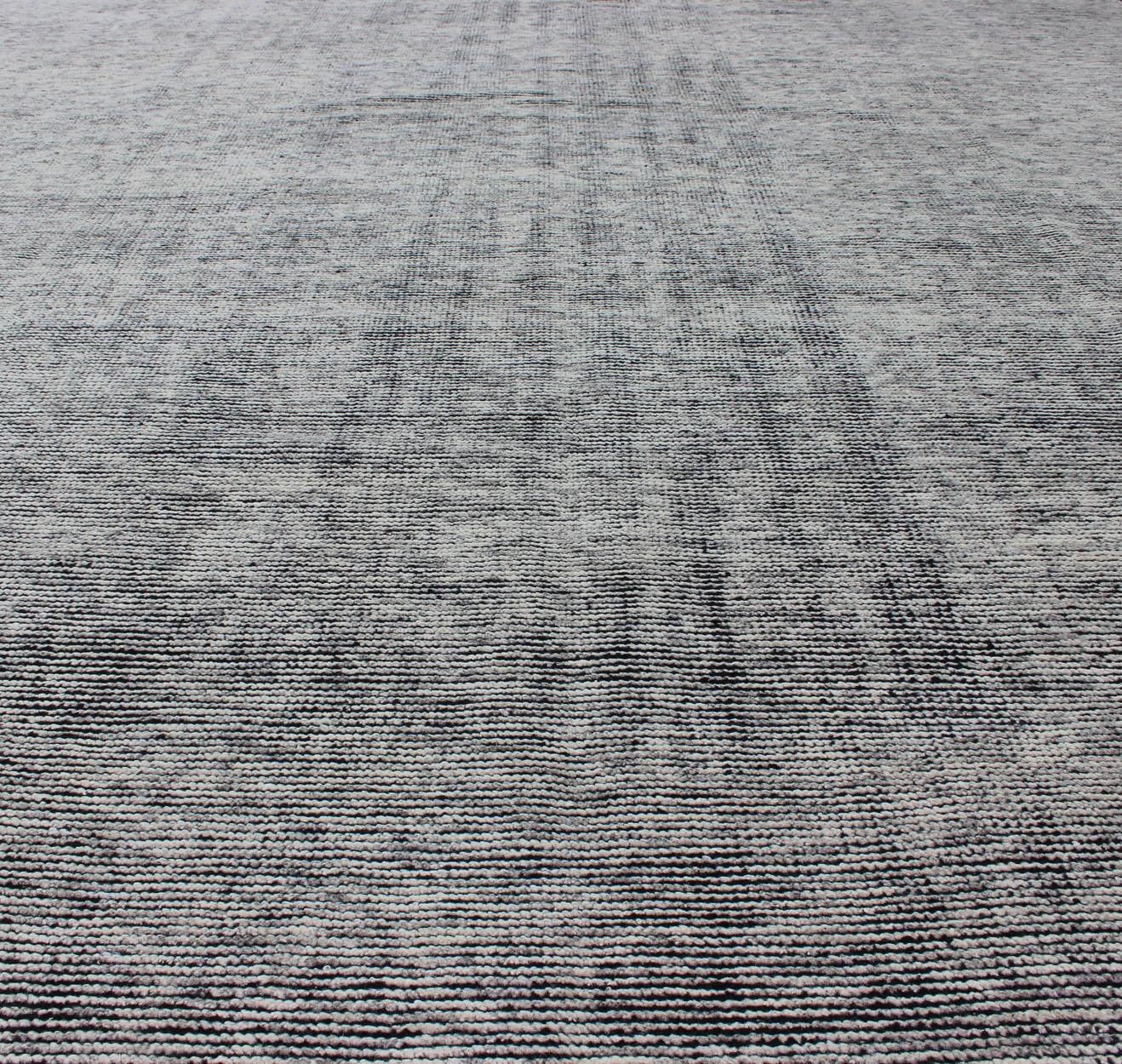 Keivan Woven Arts Hand-Knotted Modern distressed in solid field with Black and White     

Measures 9'2 x 11'10 

This modern distressed rug was hand knotted in the 2010s. The entire piece has a black background, with off-white wool woven on top to