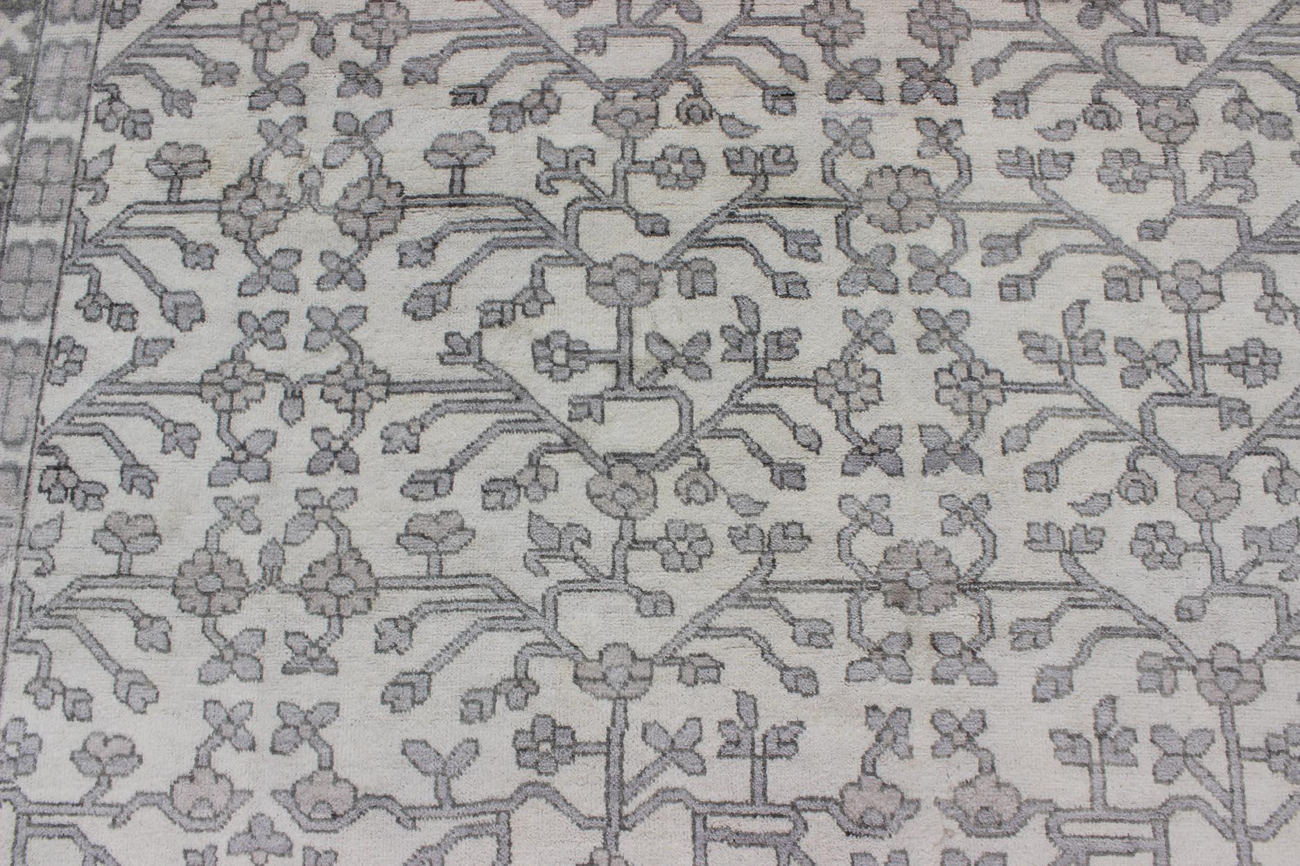 Khotan Rug in Wool with All-Over Design in Cream and Gray By Keivan Woven Arts 
Measures: 9'6 x 13'6.  
This modern Indian Khotan rug has been hand-knotted in wool and features an all-over, sub-geometric design rendered in cream and gray tones. A