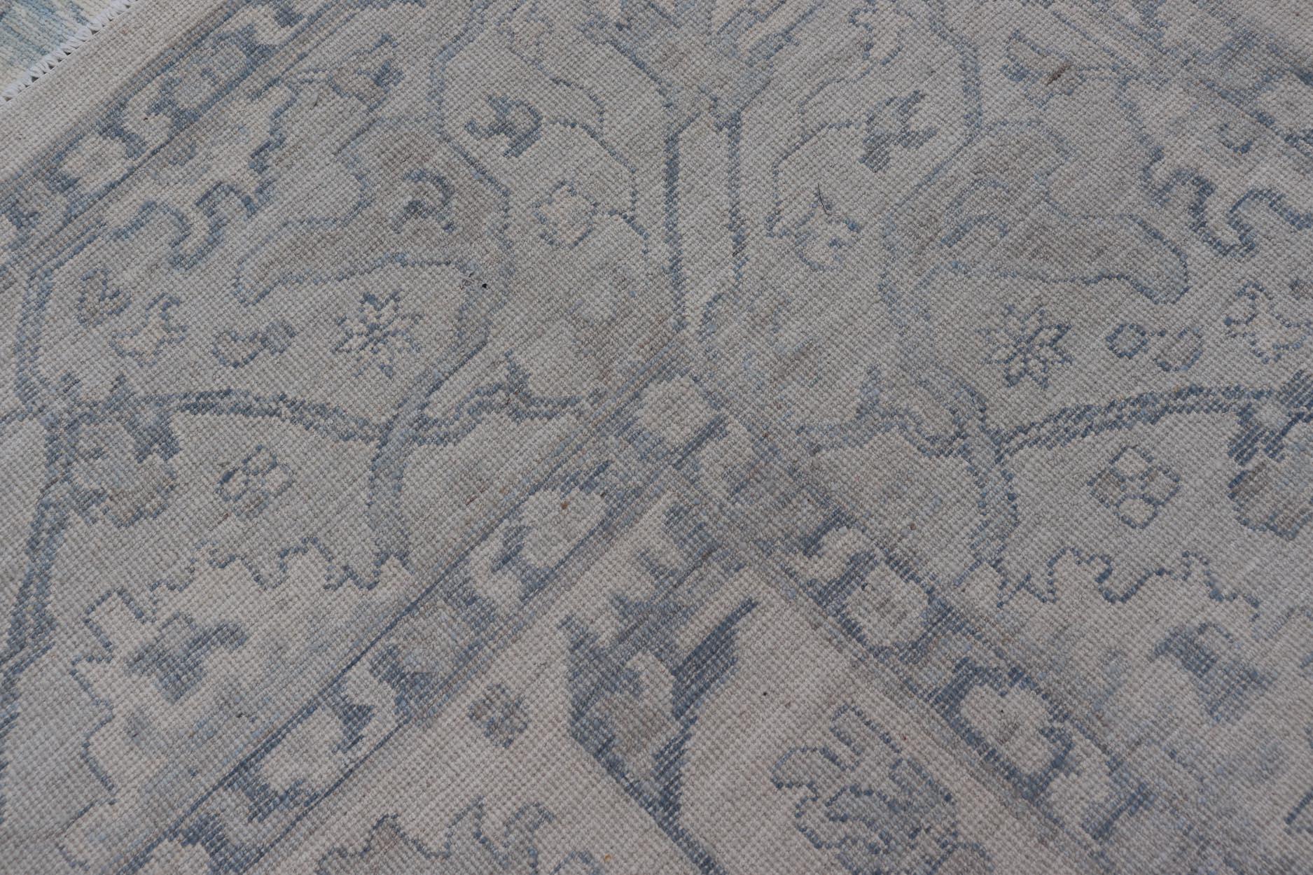 Keivan Woven Arts Oushak moderno sobre fondo crema claro y diseño azul 6