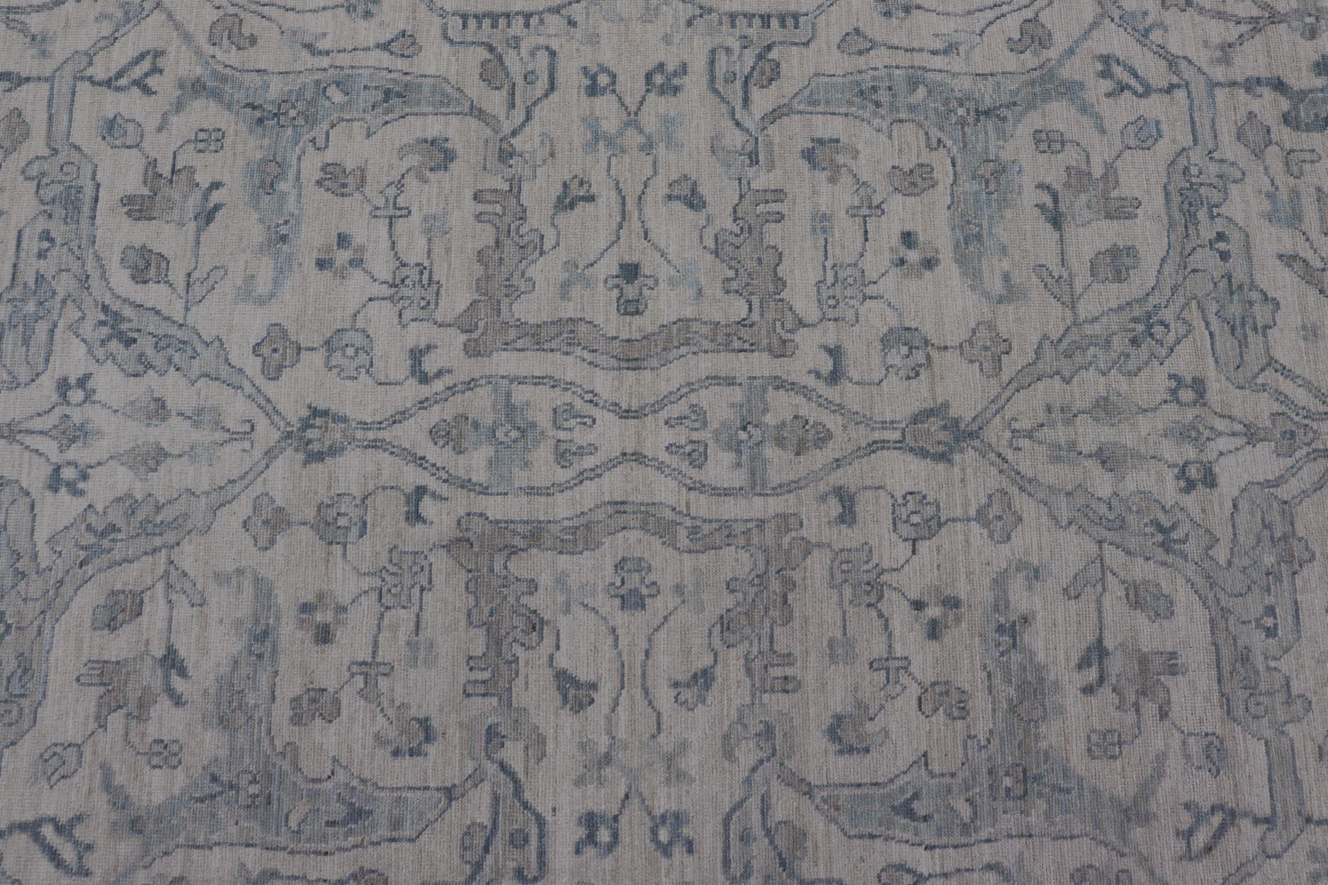 Keivan Woven Arts Oushak moderno sobre fondo crema claro y diseño azul Lana