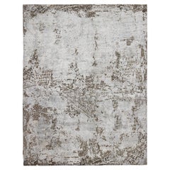 Alfombra moderna Keivan Woven Arts con cálidos colores crema, marrón claro y blanco roto