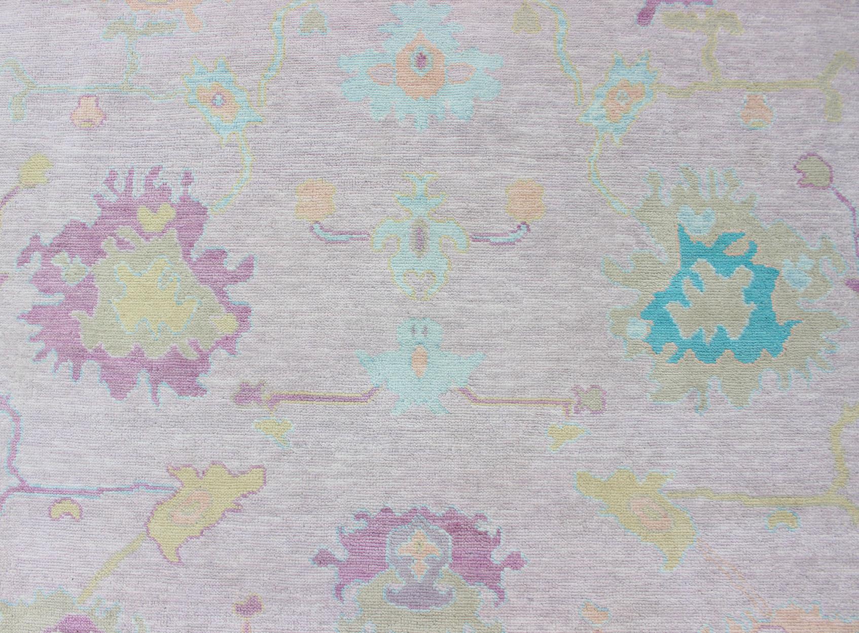 Modern Oushak Designed Rug In Wool With Light Pink and A Ice Blue Border by Keivan Woven Arts.
Measures 9'5 x 12'1
This fantastically whimsical piece was hand knotted in India during the 2010's. This Oushak features a classic floral design, but with