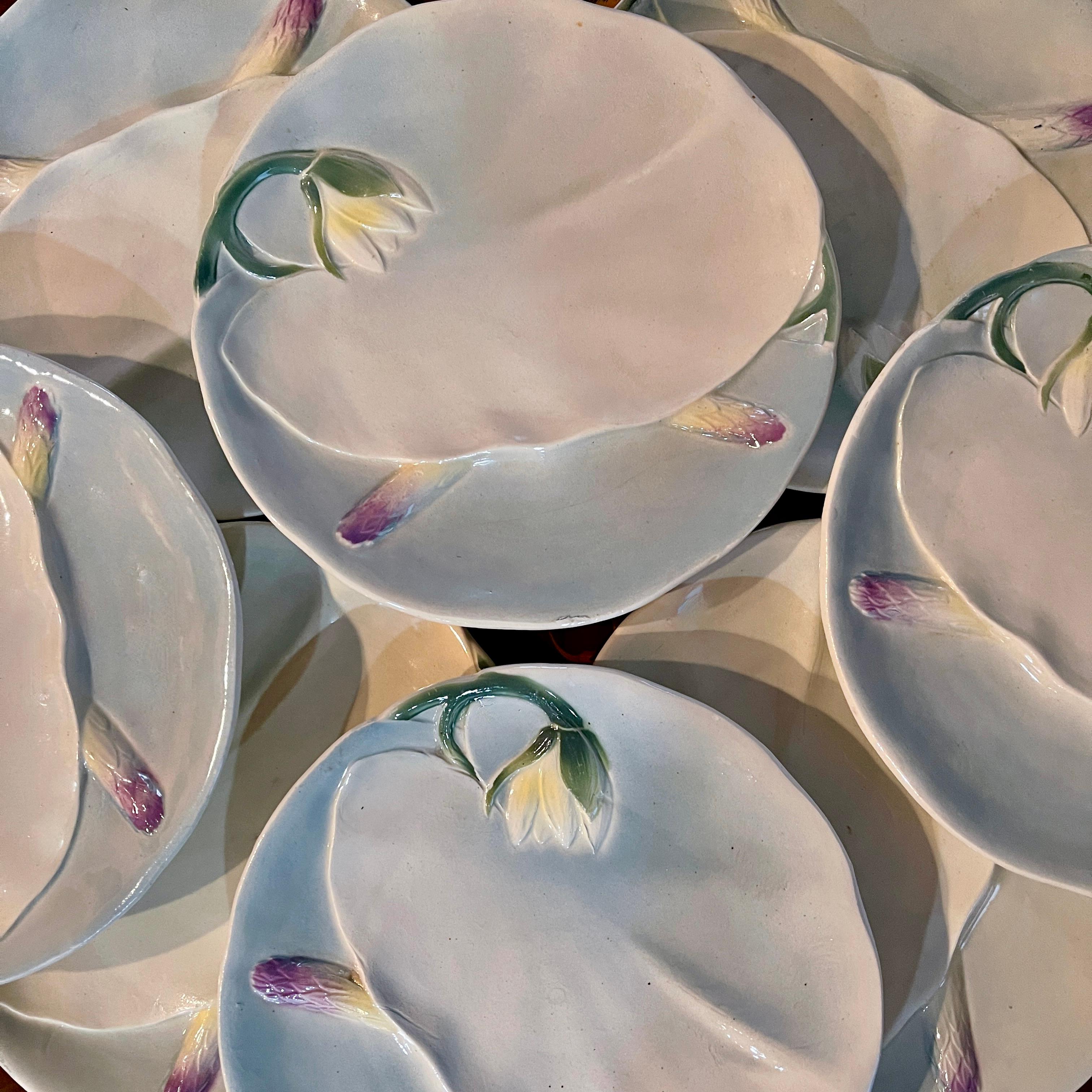 From the Keller and Guerin St. Clément faïencerie, a Water Lily themed Asparagus plate, France, circa 1900.
Soft water color like glazing distinguishes this Art Nouveau period Water Lily Asparagus plate. 
Formed as a Pond Lily leaf with a bloom,