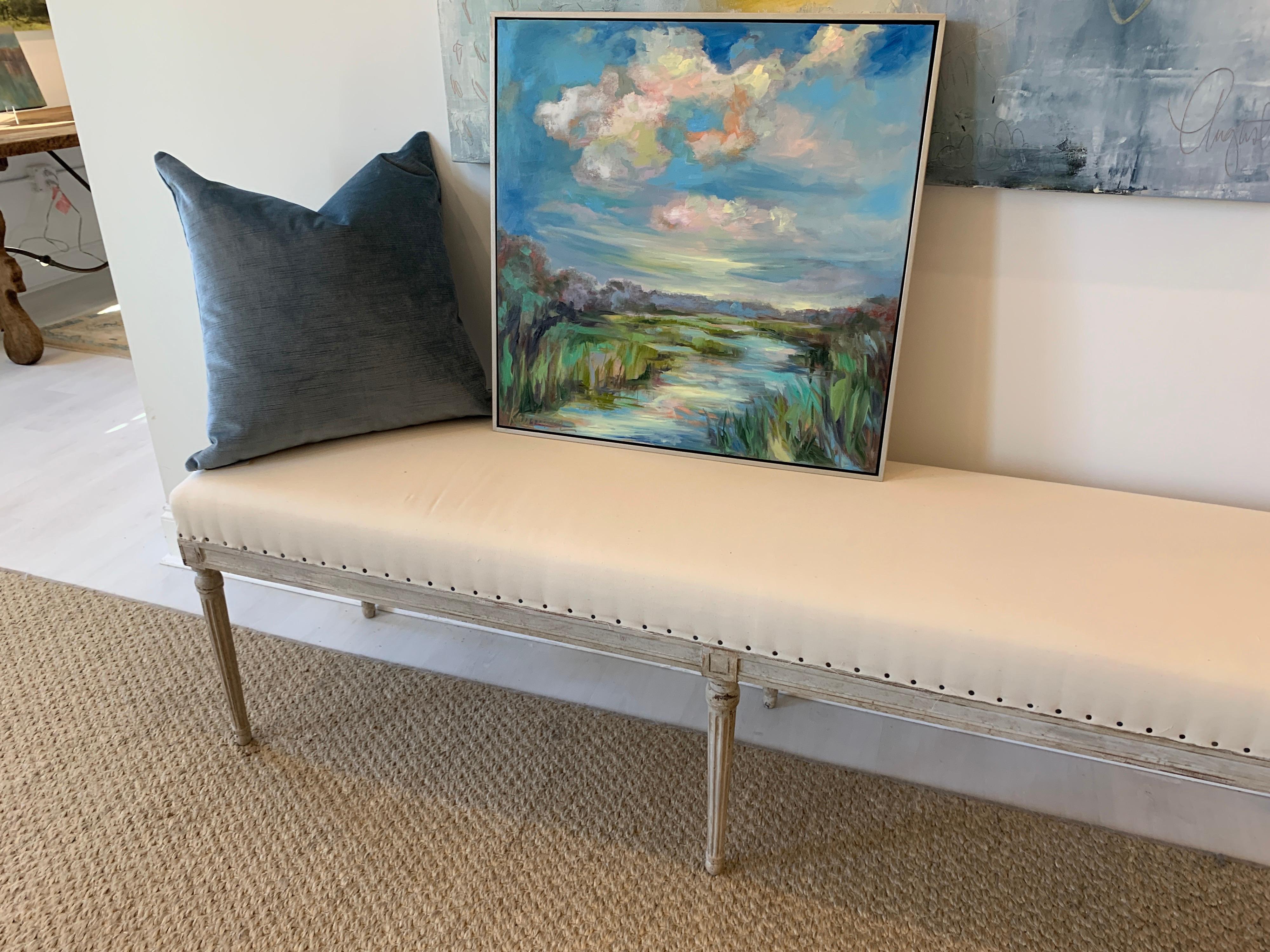 'Cloud Escape' is a medium framed oil and wax on canvas abstracted landscape created by American artist Kelli Kaufman in 2021. Featuring a palette mostly made of blue and green, this square format piece depicts a marsh on the Gulf Coast. The central