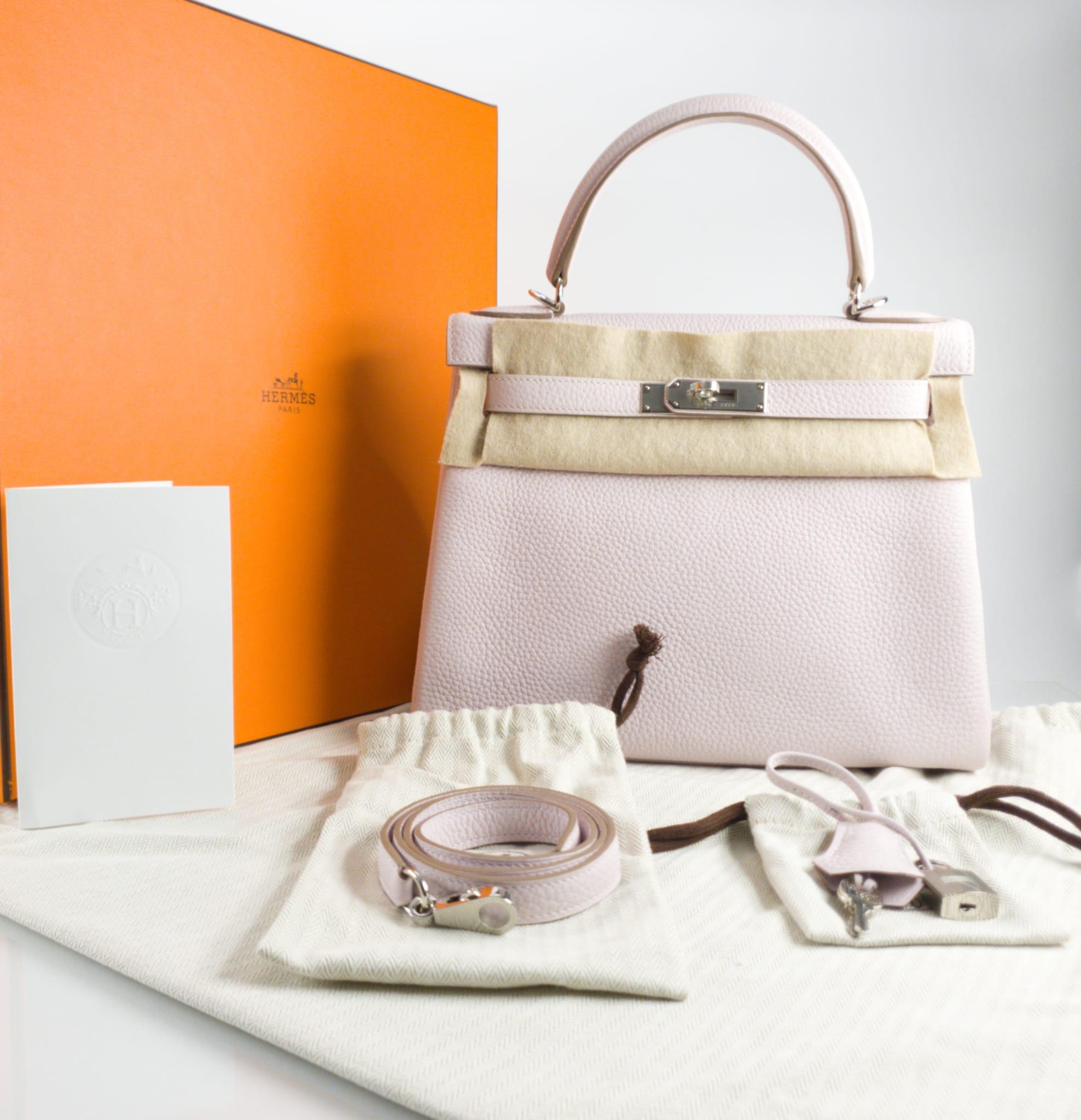 Hermès Kelly 28 Retourne Mauve Pale Taurillon Clemence leather and Palladium hardware 2023 -Brand New in Box
Includes lock, two keys, clochette, clochette dust bag, care booklet, raincoat, dust bag, and box