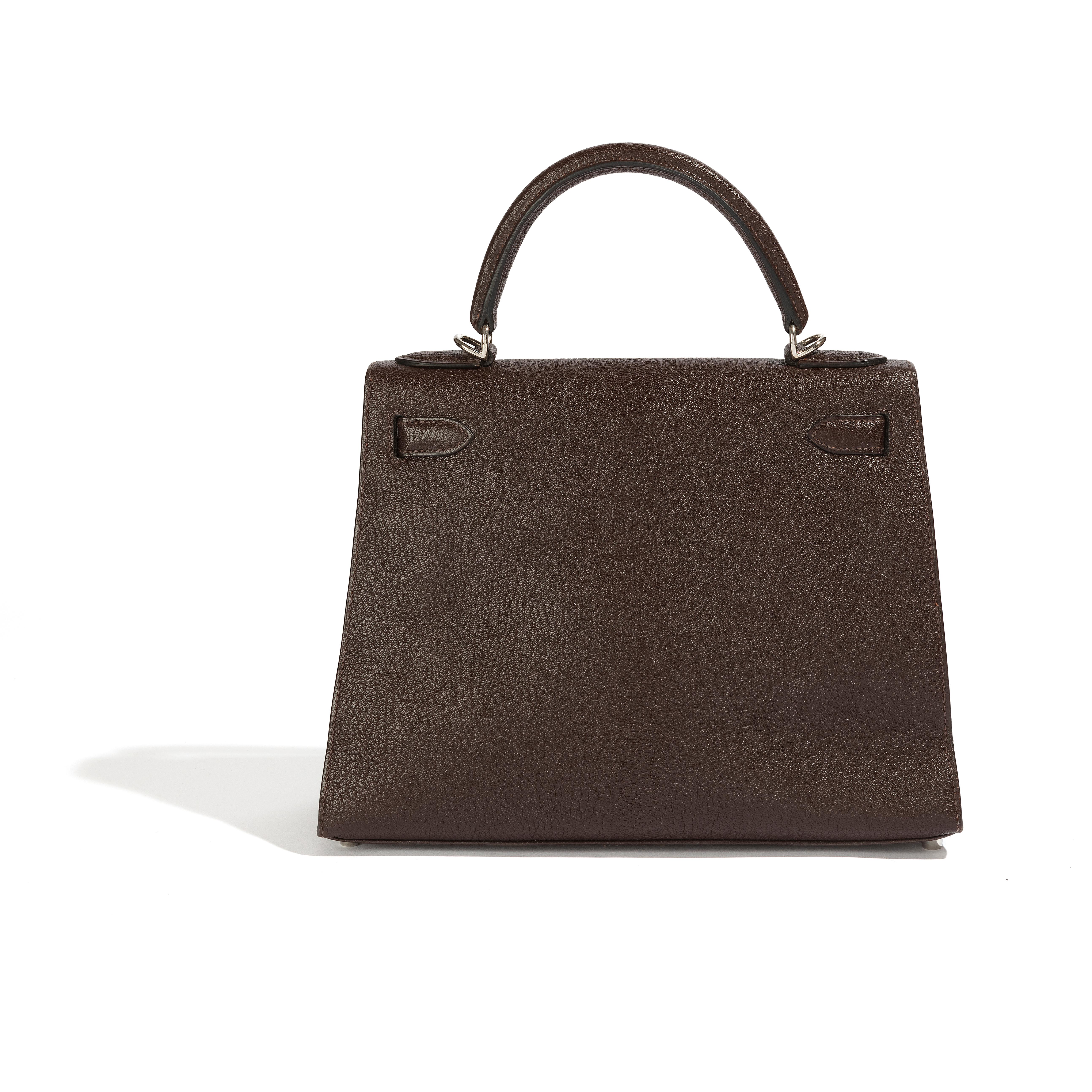 Expertly crafted Kelly 28 Sellier Brown handbag with palladium hardware. It has been used only a few times and is in very good condition. However, there is a small mark on the base and another one on the back, which you can refer to in the images