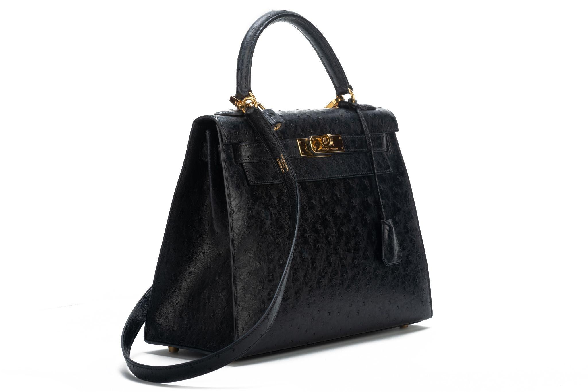Hermes rare and collectible Kelly Bag 28 sellier in black ostrich leather and gold tone hardware. Date stamp X for 1994. Detachable strap. Comes with clochette, tirette, lock, keys, original box.