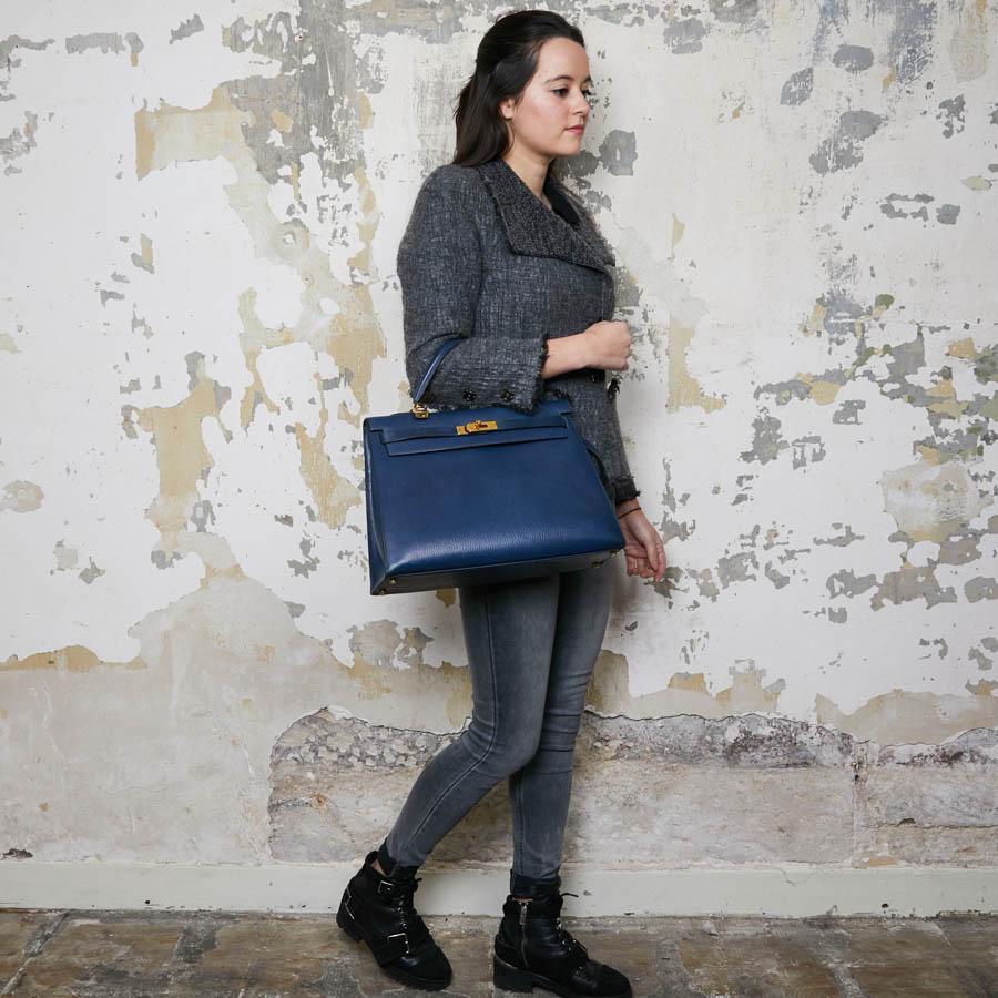 A must-have Kelly 35 bag from Maison Hermès, in a blue Prussian leather. It is worn by hand or shoulder by a removable shoulder strap. The lining is in smooth blue leather with 3 pockets, one with zipper. The hardware is golden brass (micro