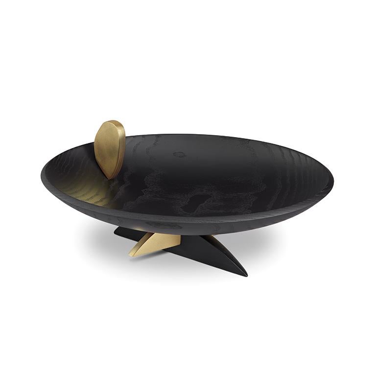 This provocative footed serving bowl is sculpted in ebonized European oak and adorned with brass accents; it embodies the sophisticated artistry of the L'Objet Kelly Behun collaboration.

DETAILS
12 L x 8 W x 5.75 H in (30 L x 20 W x 15 H