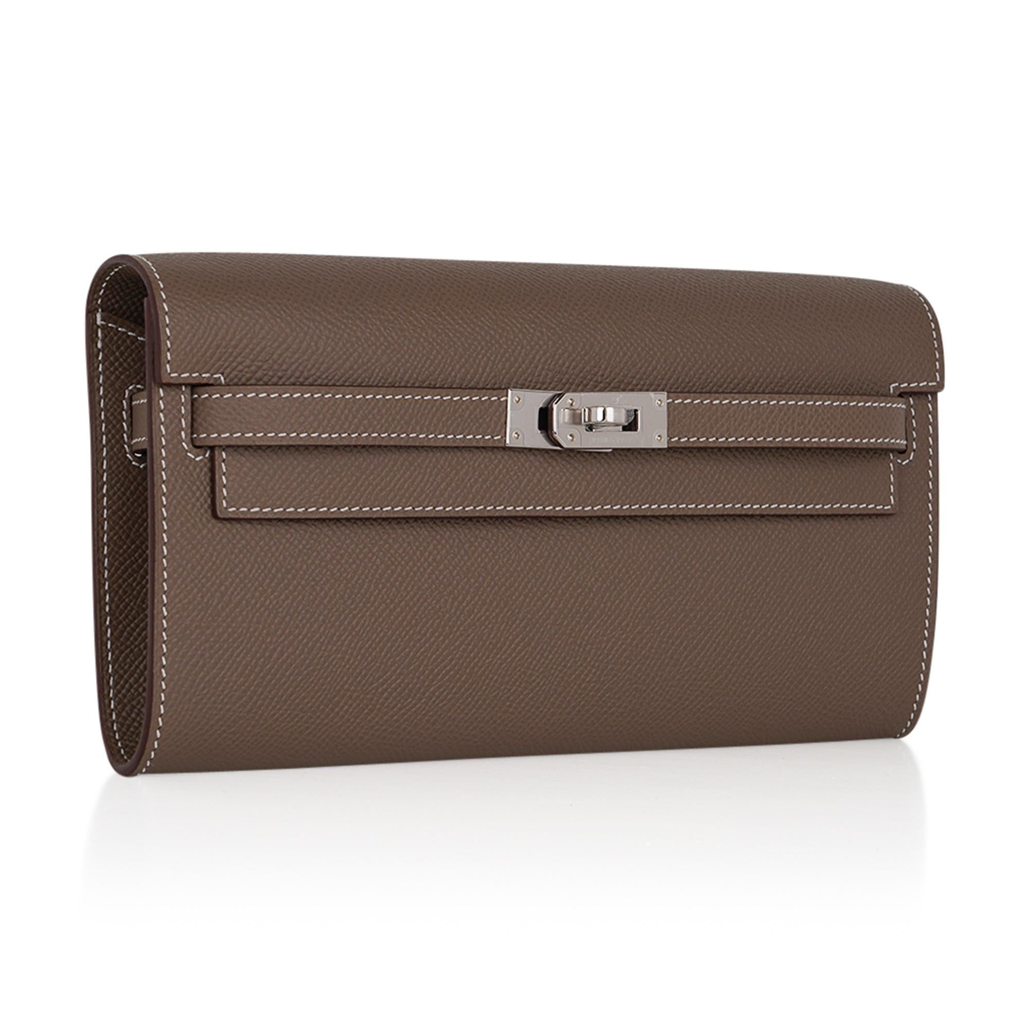 Mightychic offers an Hermes Kelly Classique To Go wallet featured in Etoupe with signature bone topstitch.
Epsom leather.
Fresh with Palladium hardware.
Removable shoulder strap changes from a crossbody, to a wallet or clutch.
Interior has four (4)