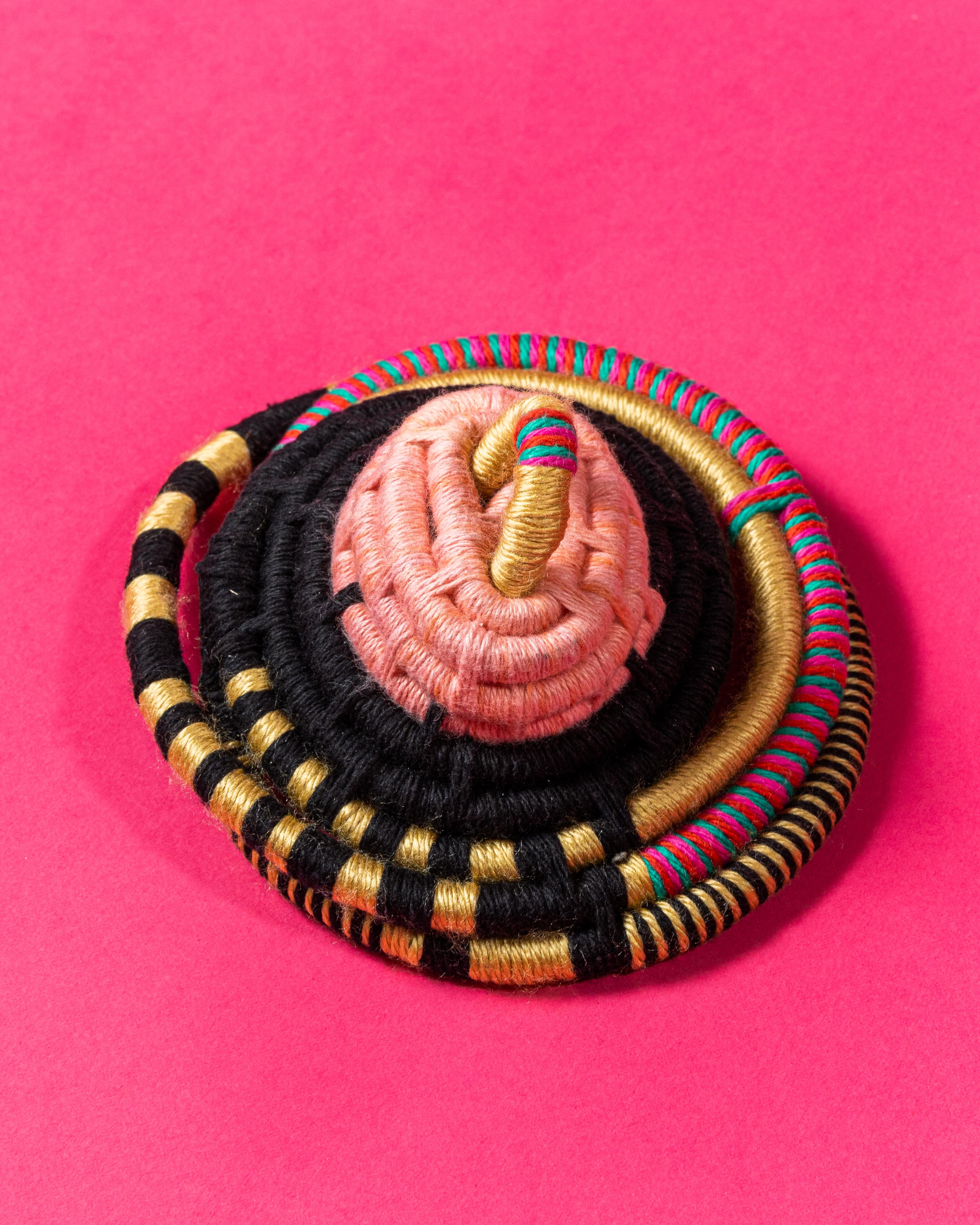 Coiling cord and cotton yarn textile sculpture.  Pink, gold, black, green, fuchsia fiber art, fine art basketry. 

This 