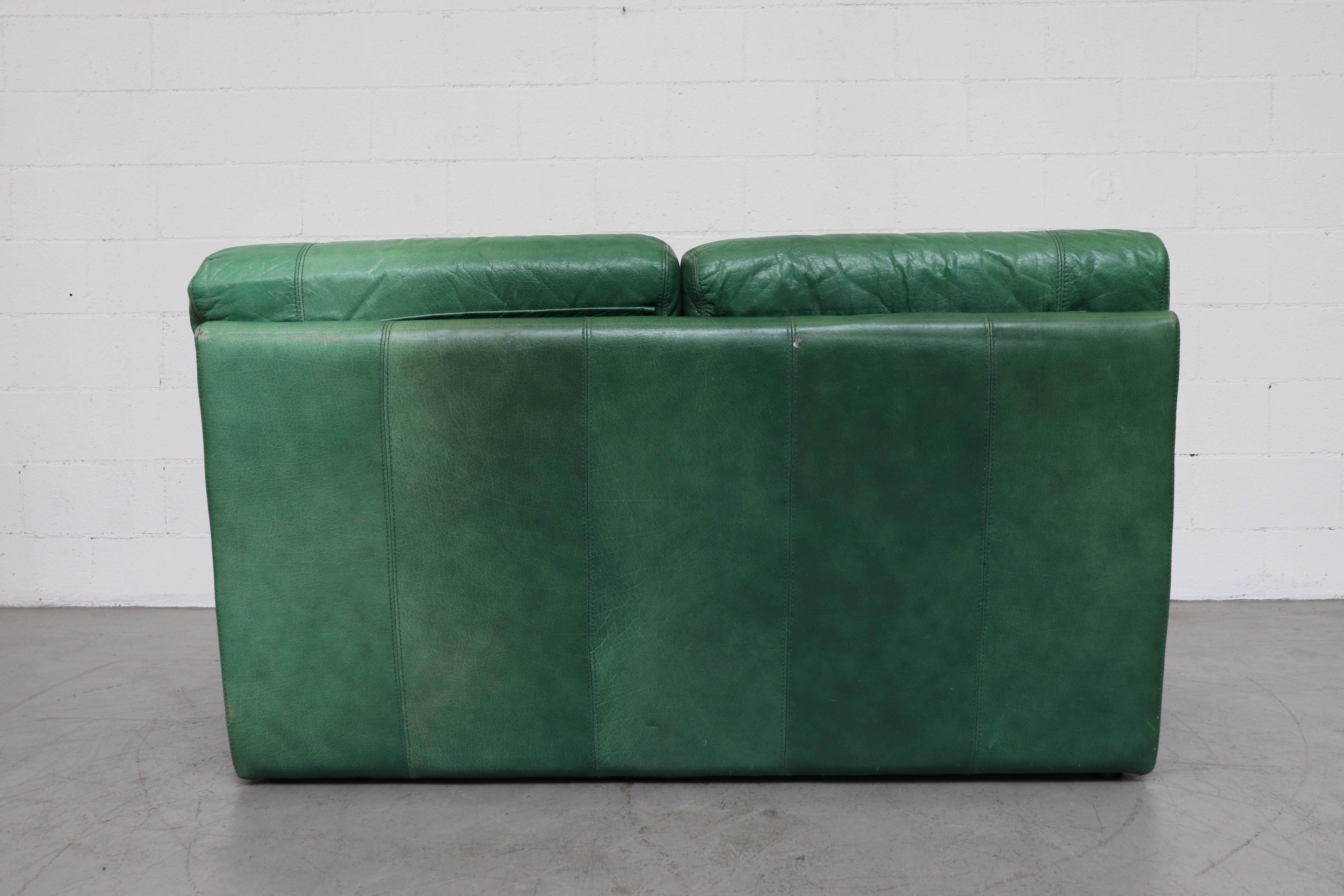 green leather sofa and loveseat