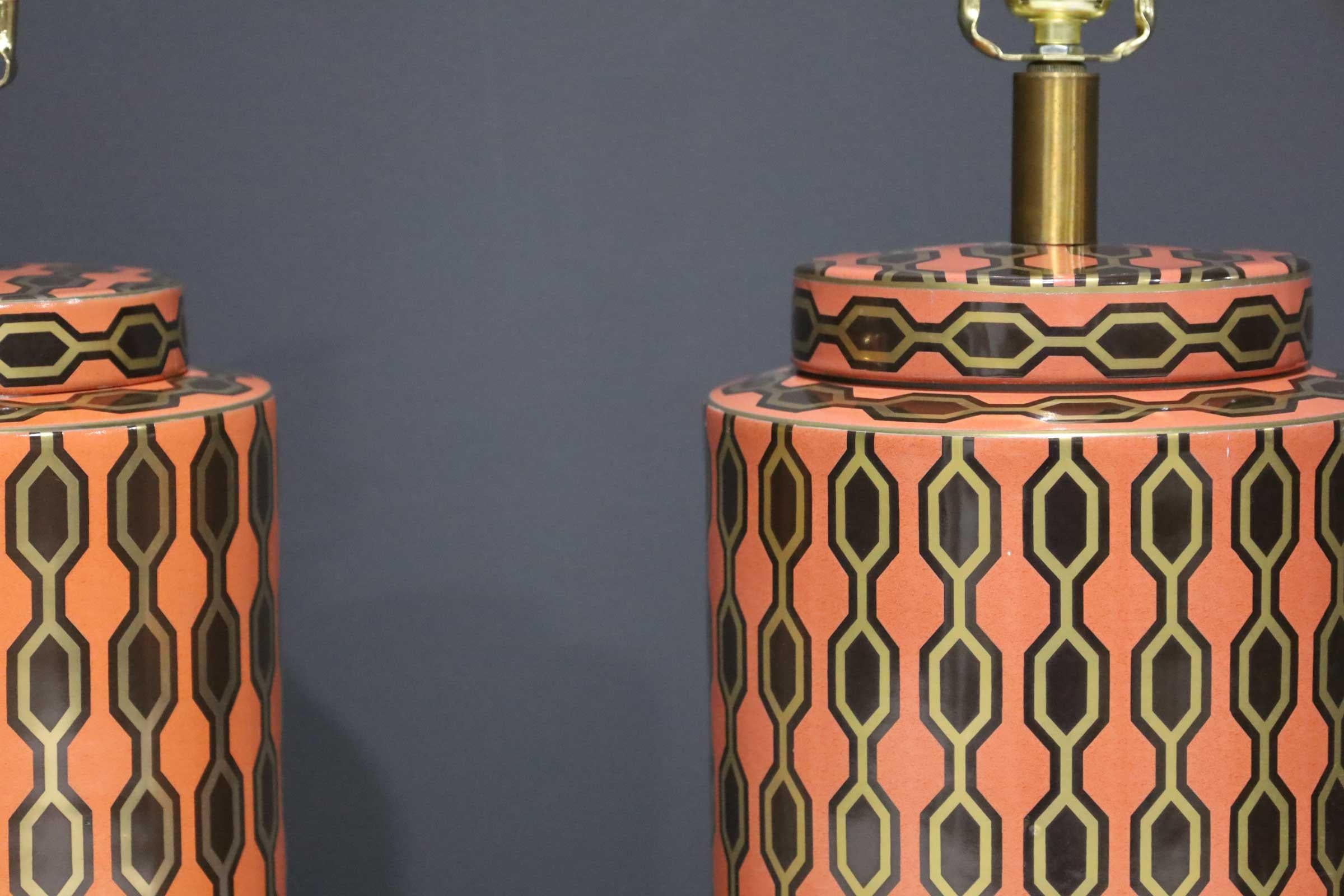 Vibrant geometric pattern in orange, gold and brown make these porcelain lamps stand out in any room. Add finials and a shade of your choice.