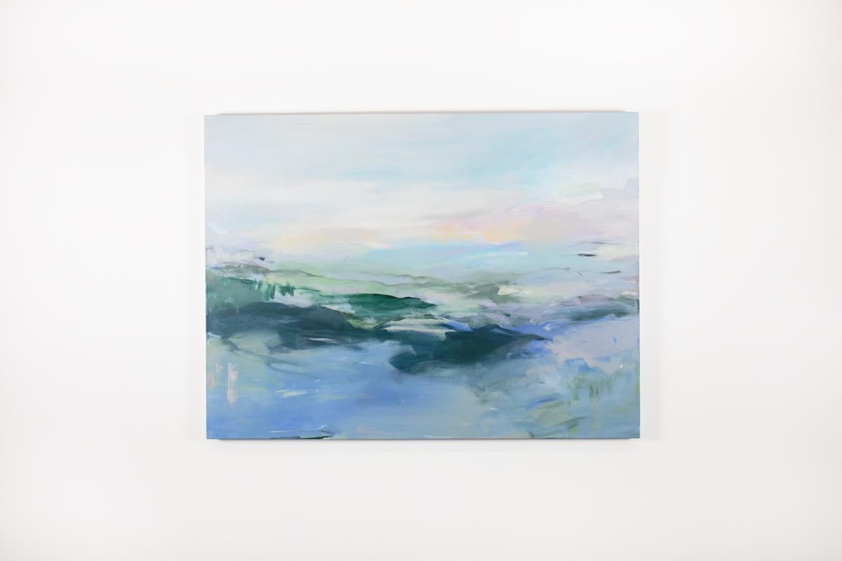 This large abstract statement painting by Kelly Rossetti features a blue palette with deep, earthy green and pink accents. The artist layers colors using soft brushwork and creates a balanced composition. The painting is signed by the artist on the
