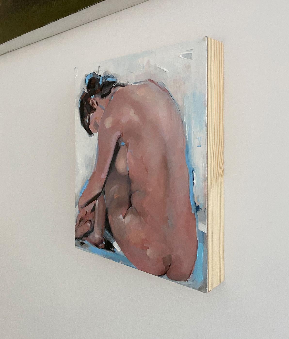 This abstract figurative painting by Kelly Rossetti is made with oil paint on cradled board. It captures a view from behind a nude woman who is hugging her legs to her chest. While the form is overall a deep, warm color, the artist has added