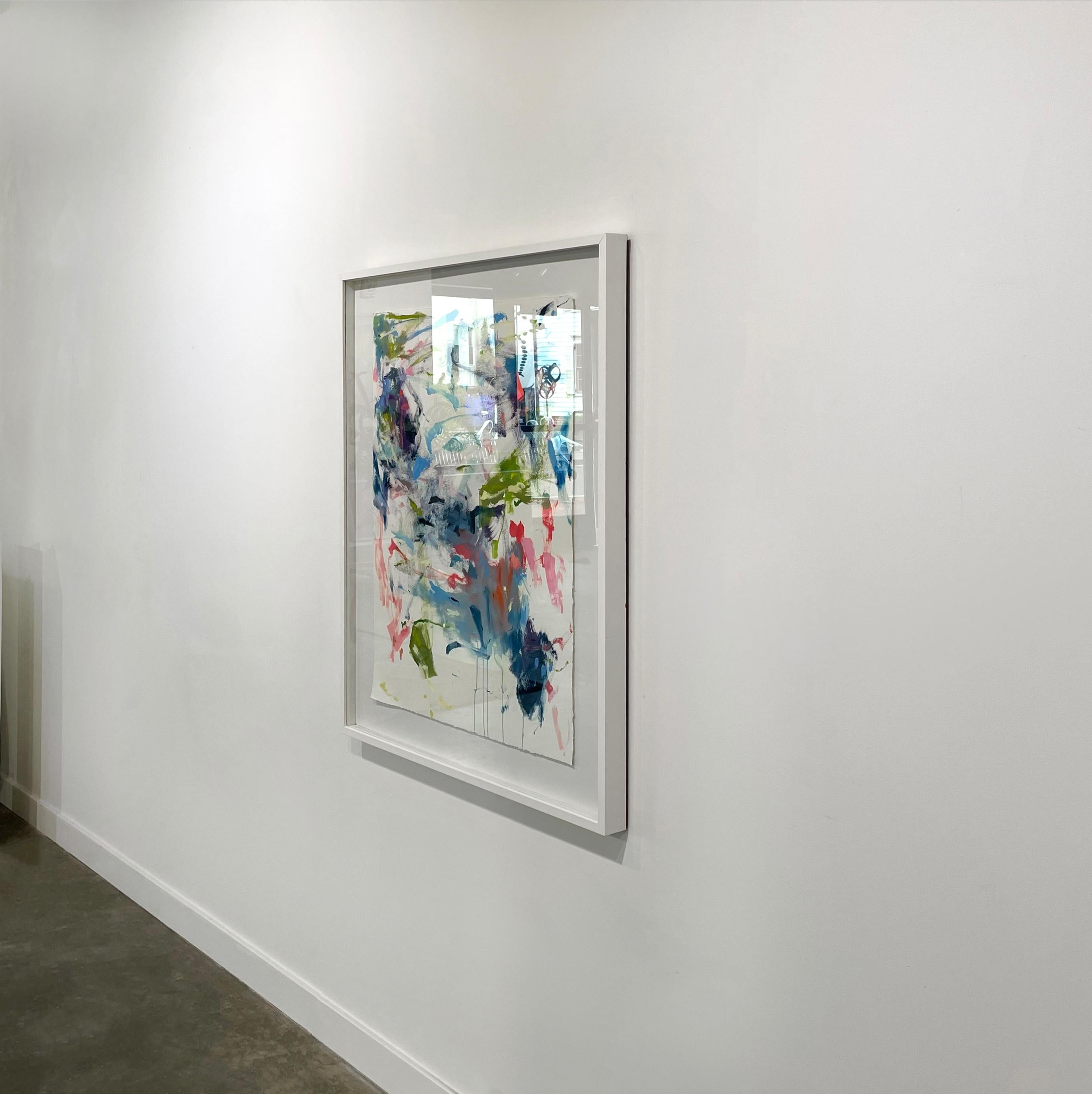 This contemporary abstract painting by Kelly Rossetti is made with oil paint on paper. Energetic strokes of blue, red, and green come together on a white background to create a lively, expressive piece. The painting itself is 22