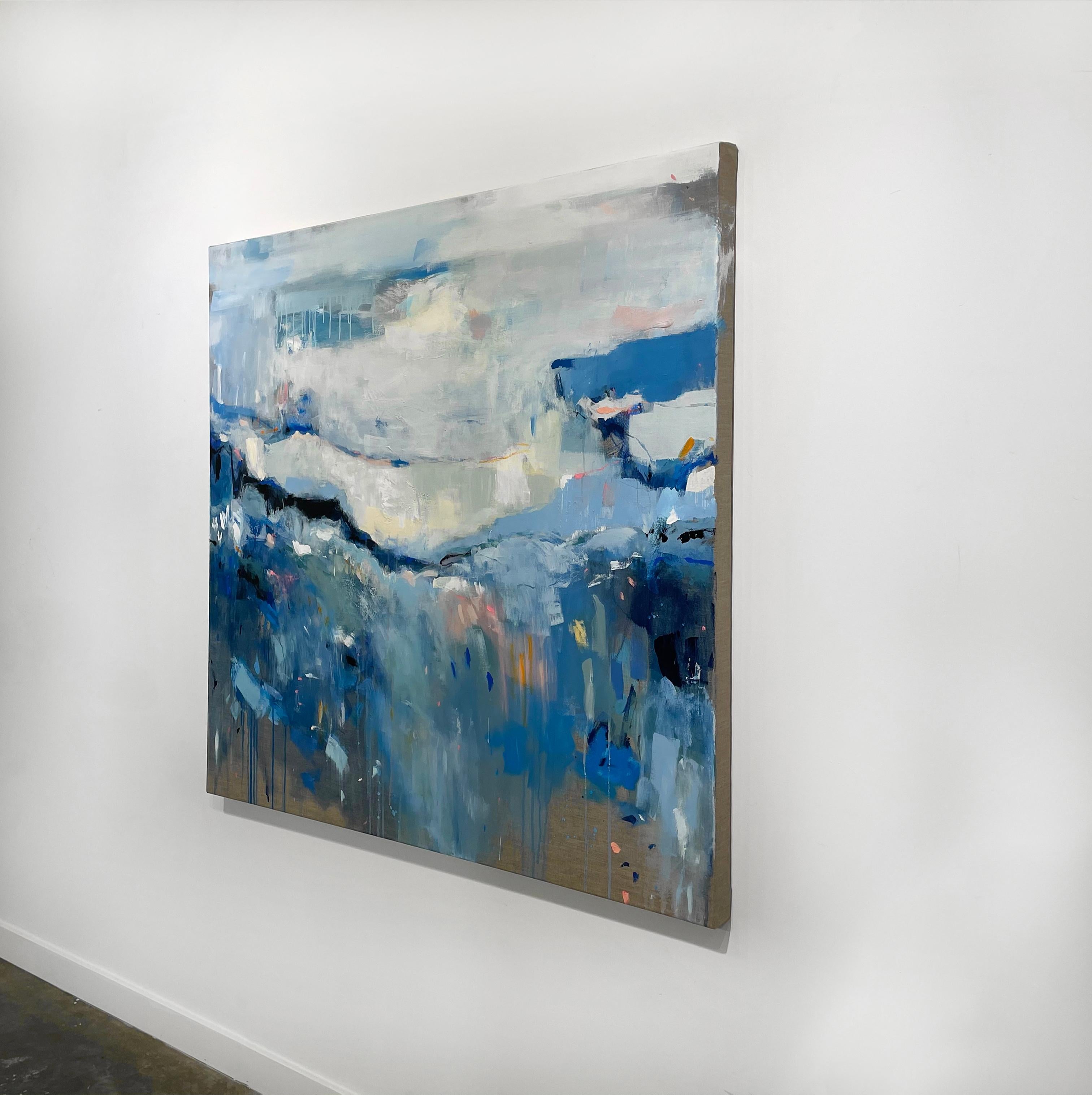This contemporary abstract painting by Kelly Rossetti is made with mixed media on linen. With a cool blue palette, it mixes varying shades and hues of blue with lighter creme and off white, with deep, near black accents and pops of warm colors like