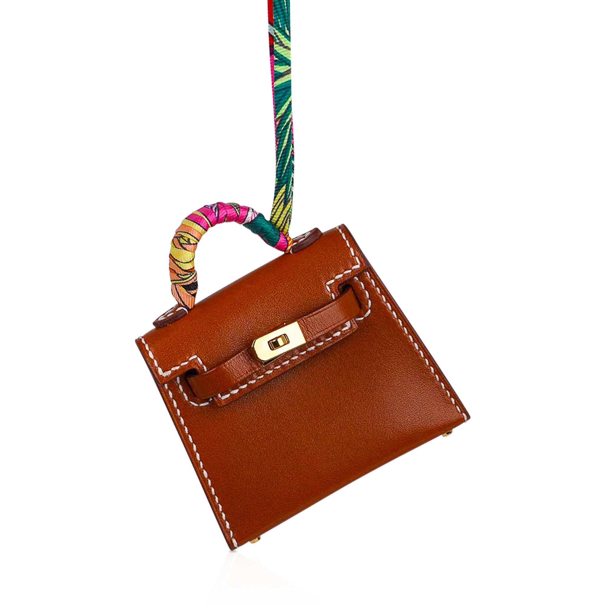 Mightychic offers a guaranteed authentic very rare limited edition Hermes Kelly Twilly Bag Charm features a miniature Kelly in Gold with signature bone topstitch.
Shaped like a Kelly Bag crafted in Tadelakt leather with amazing detail with working